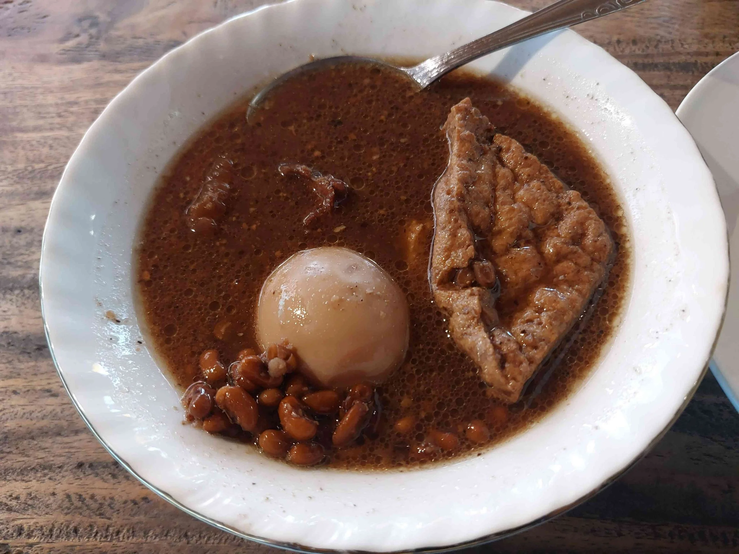 Javanese brongkos beef stew with egg, tofu, and beans in rich spiced coconut sauce
