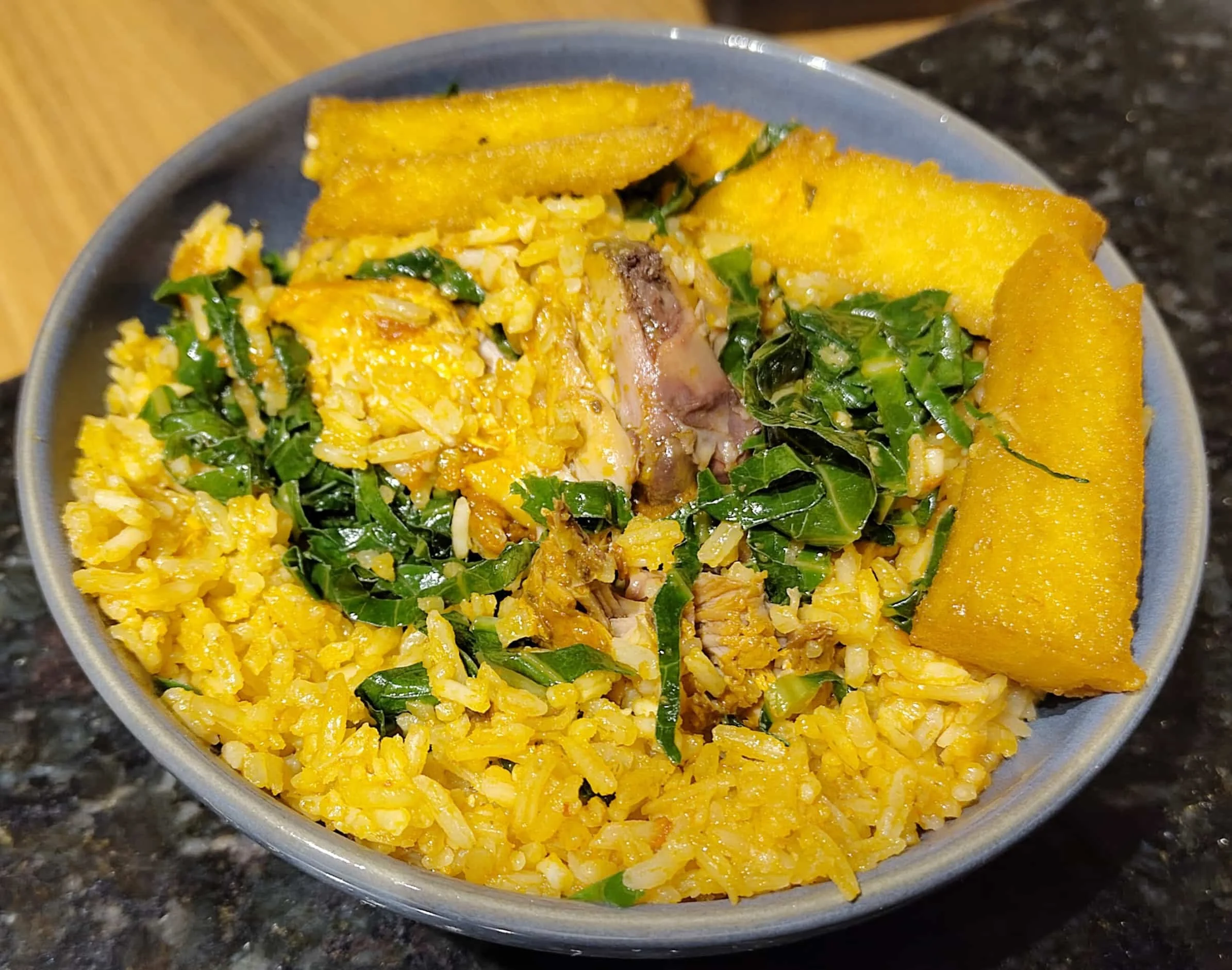 Traditional Brazilian galinhada, a chicken and rice dish served with fresh herbs