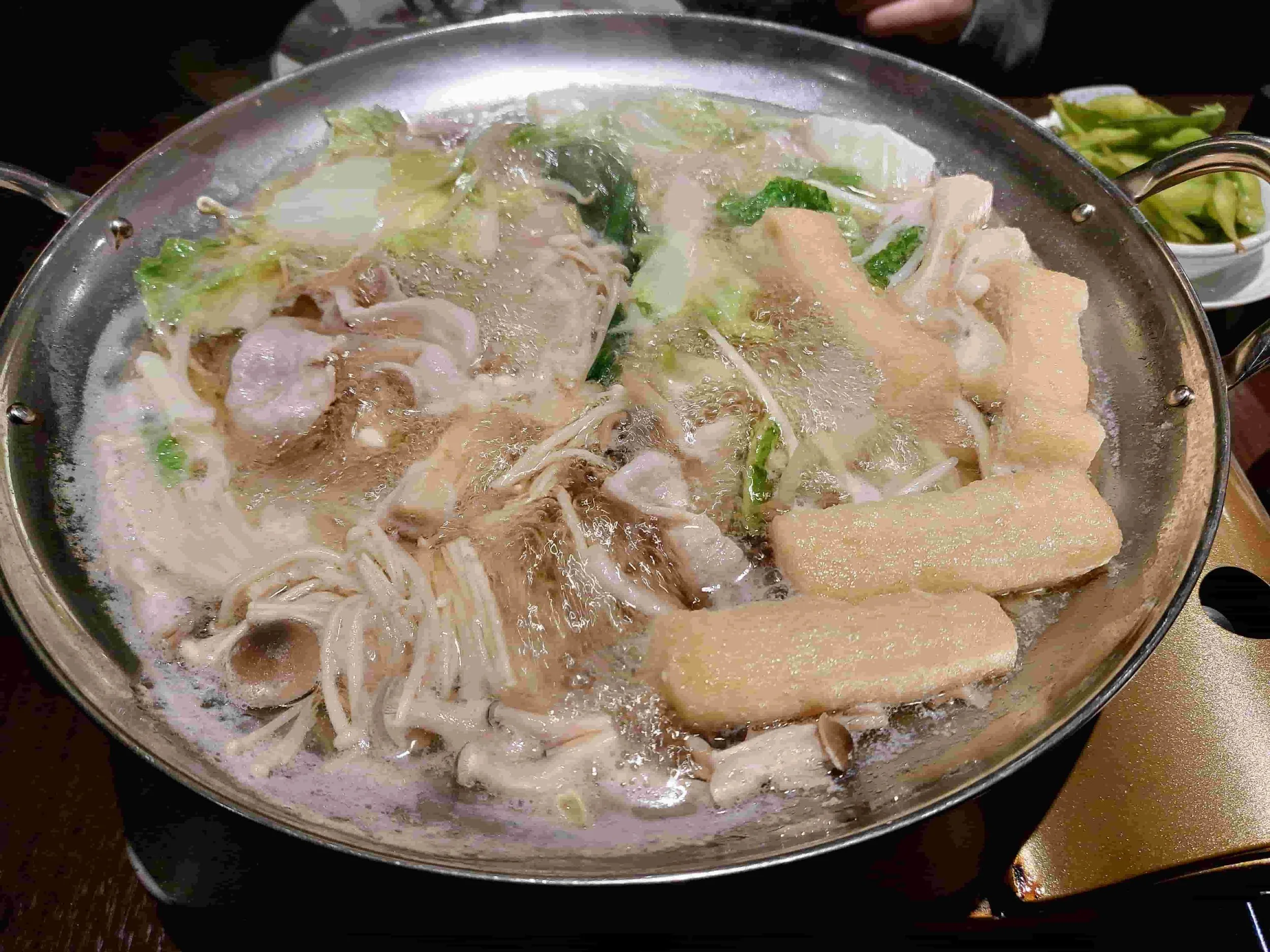 chanko nabe hot pot with chicken, vegetables, tofu, and noodles in savory broth