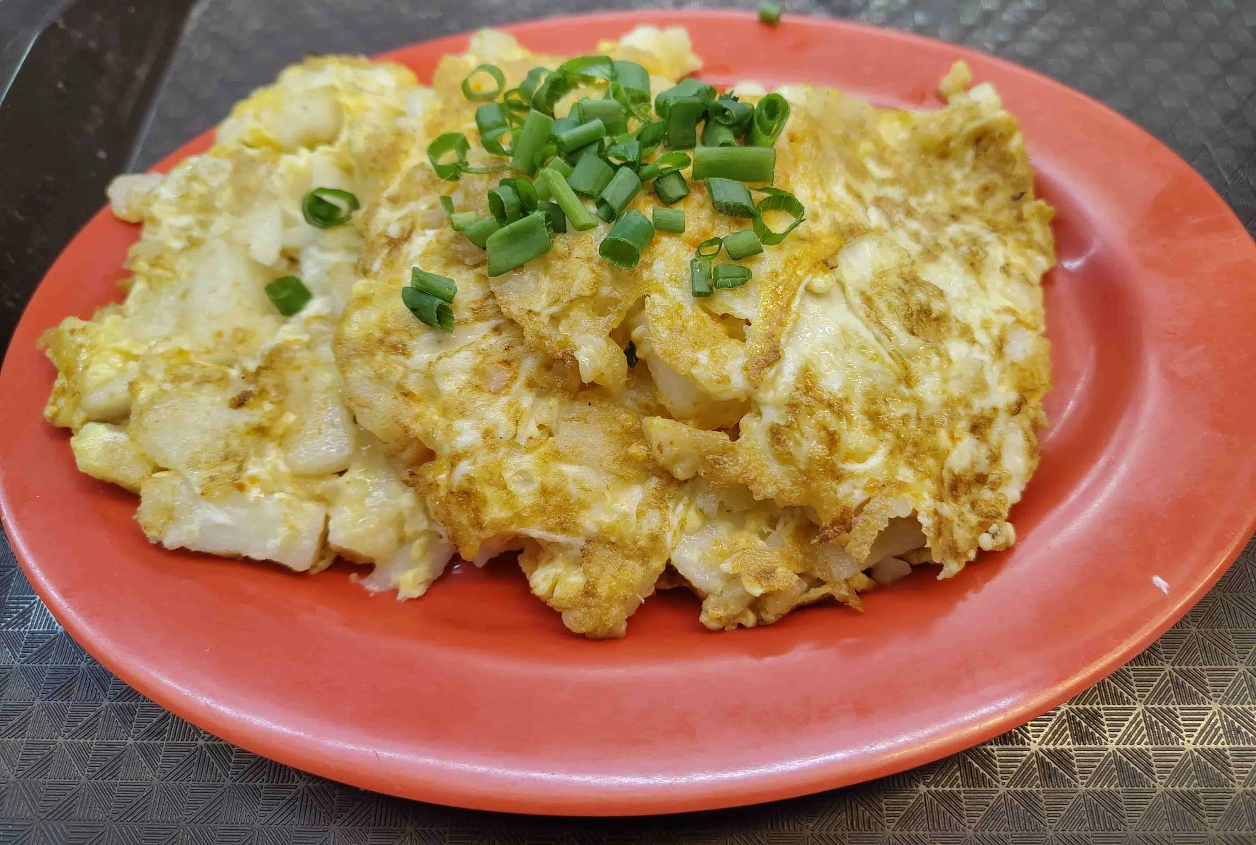 White carrot cake – Singapore stir-fried radish cake topped with spring onions