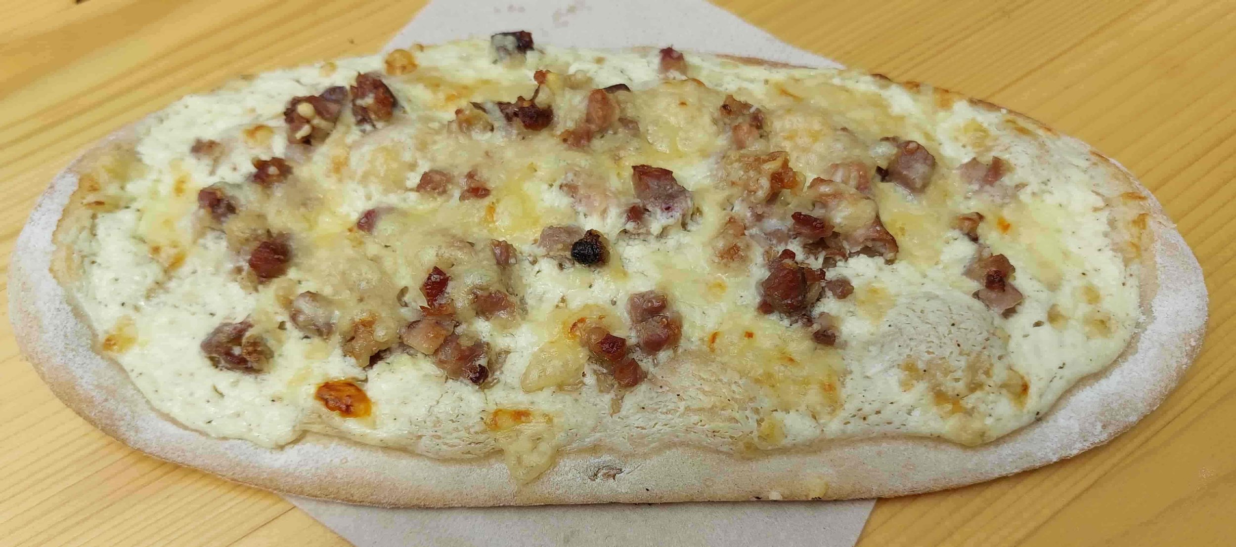 German Rahmfladen thin flatbread with cream, onions, and bacon