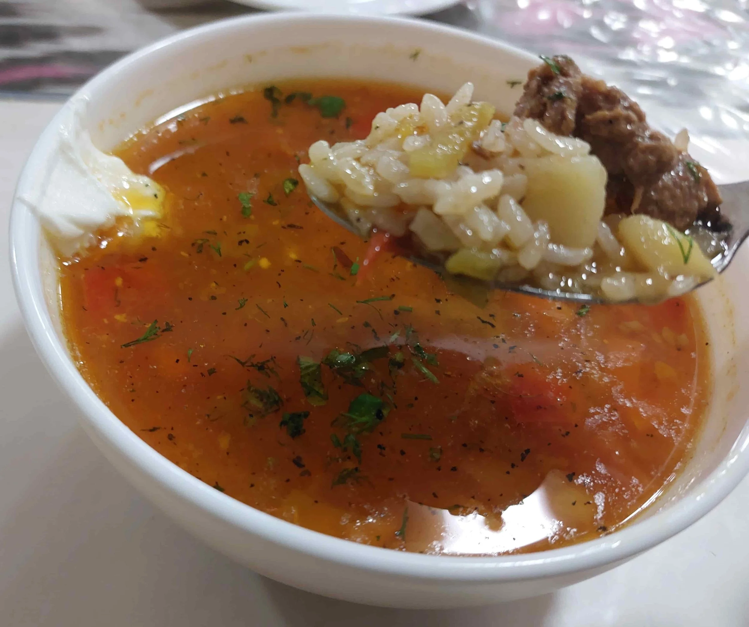 Uzbek Mastava rice soup with beef, vegetables, and herbs