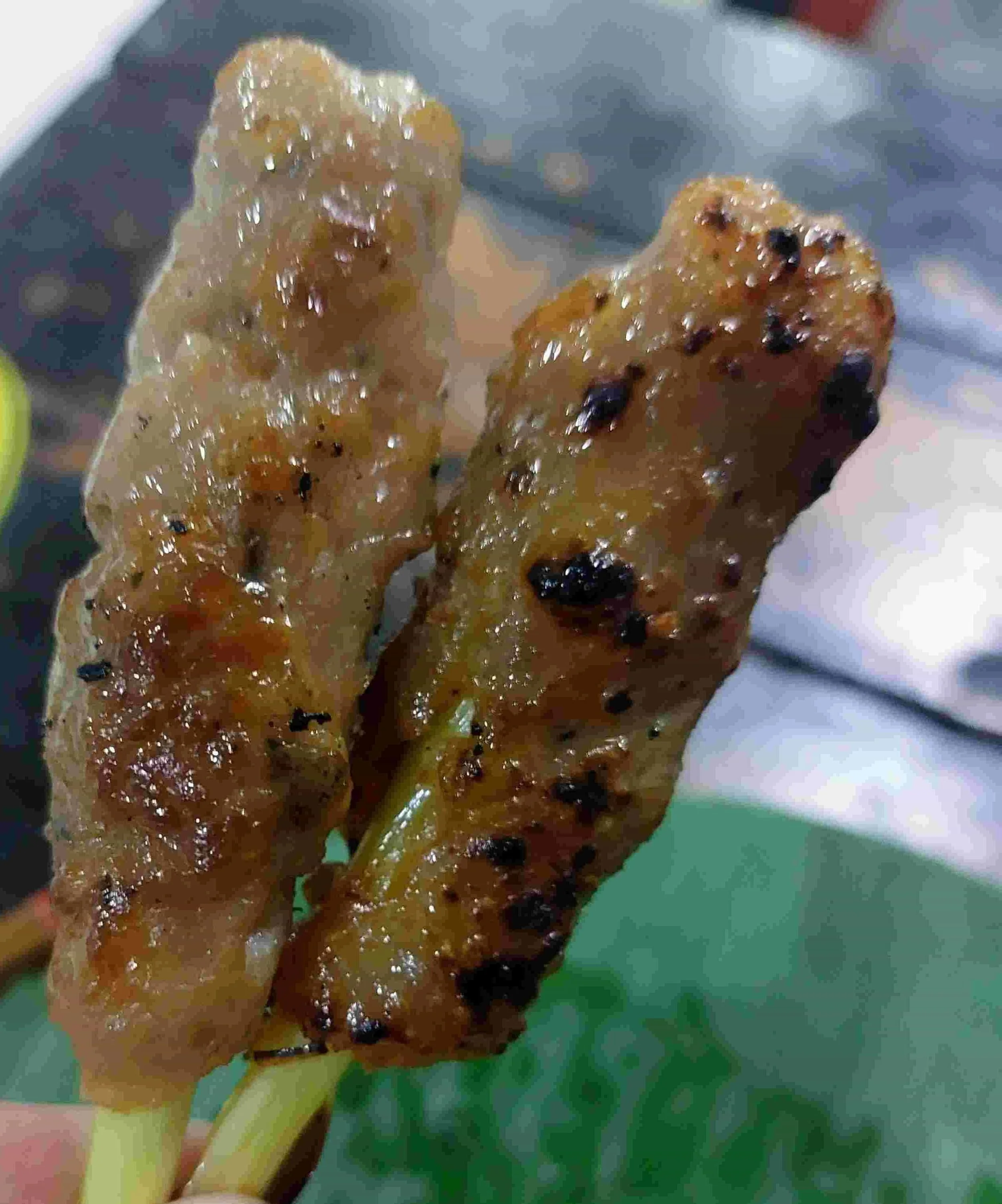 Two pieces of Nem Lụi – Vietnamese grilled lemongrass pork skewers