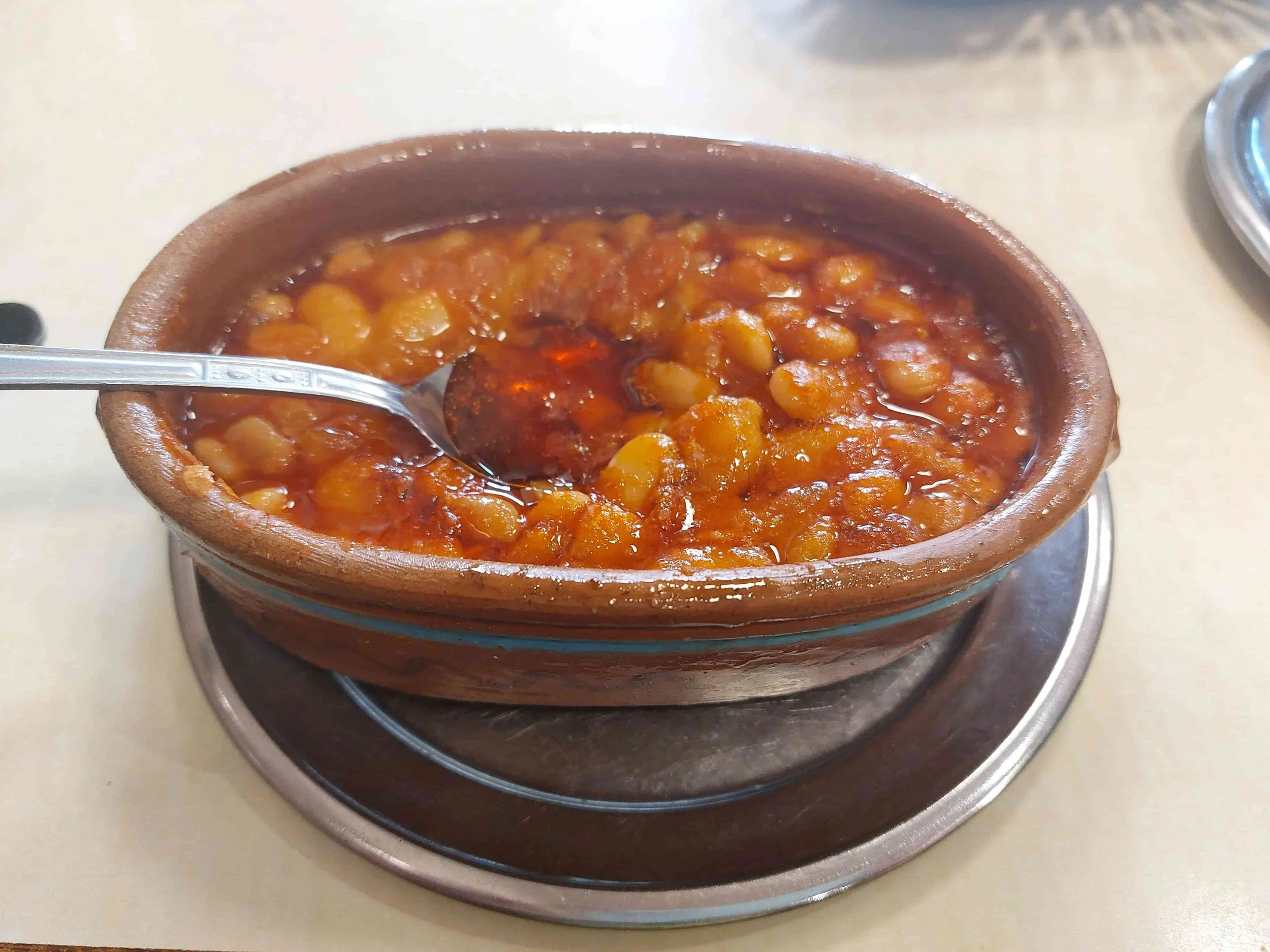 North Macedonian tavče gravče traditional baked beans with spices in clay dish