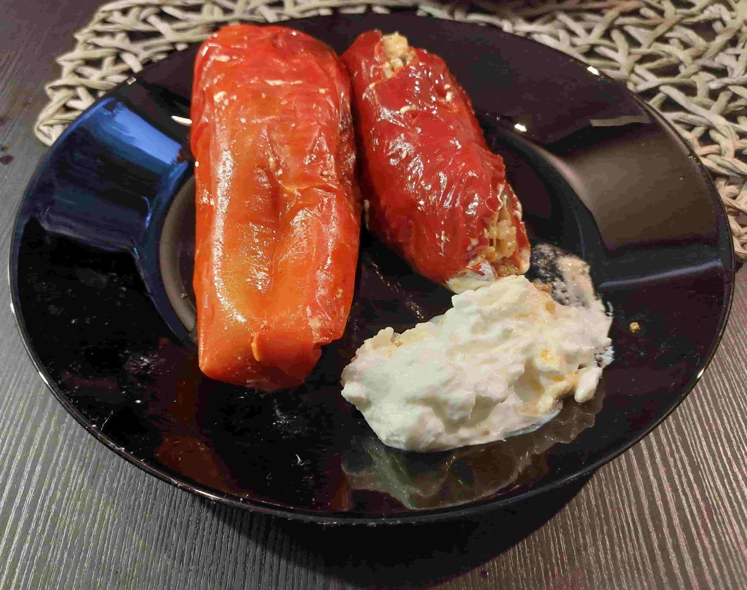 Bulgarian pŭlneni chushki stuffed peppers served with sour cream