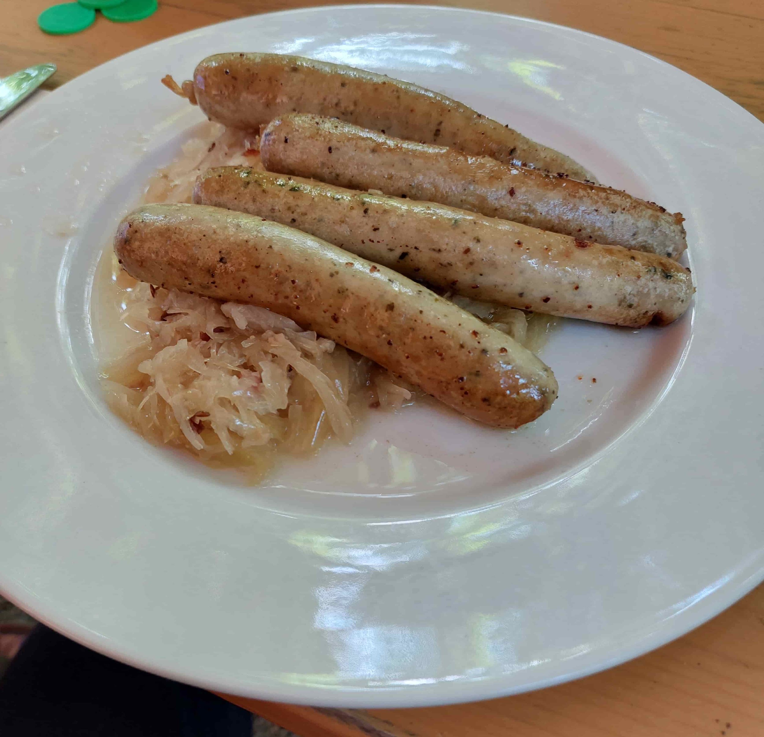 German Nürnberger Rostbratwurst small grilled sausages served with sauerkraut