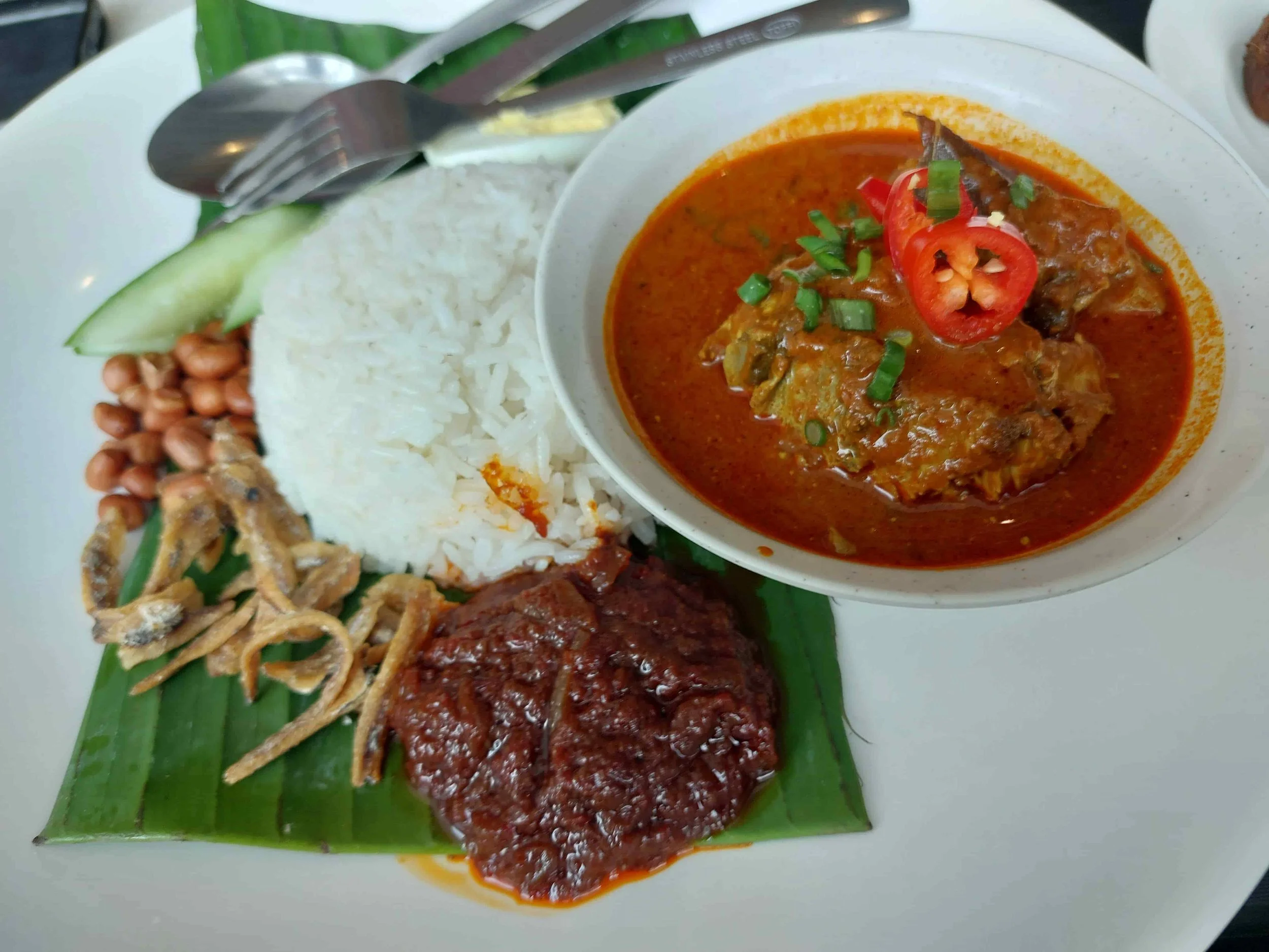Kari ayam – Malaysian chicken curry served with rice, sambal, and side dishes