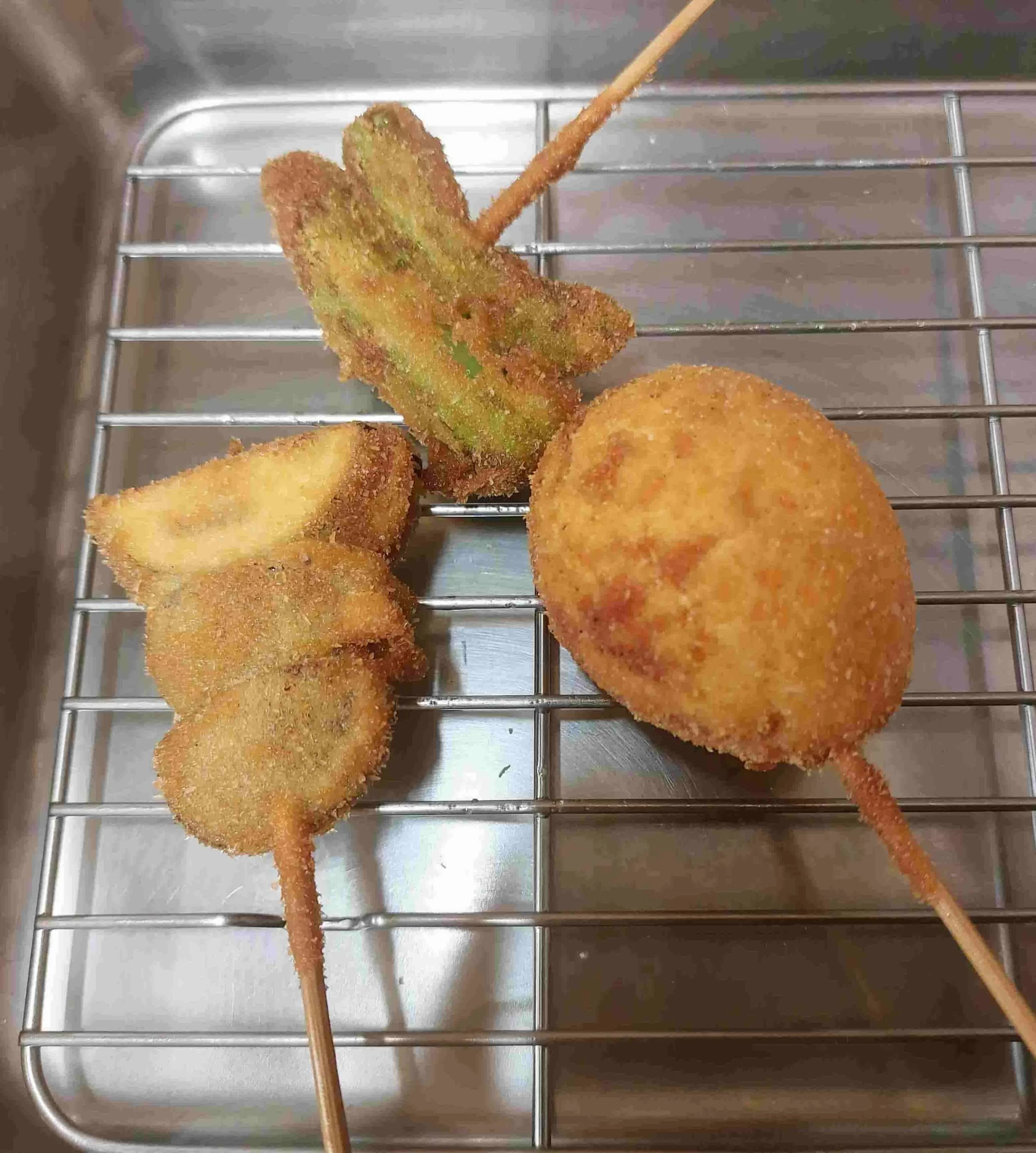 Golden crispy kushikatsu skewers with assorted fried vegetables and egg