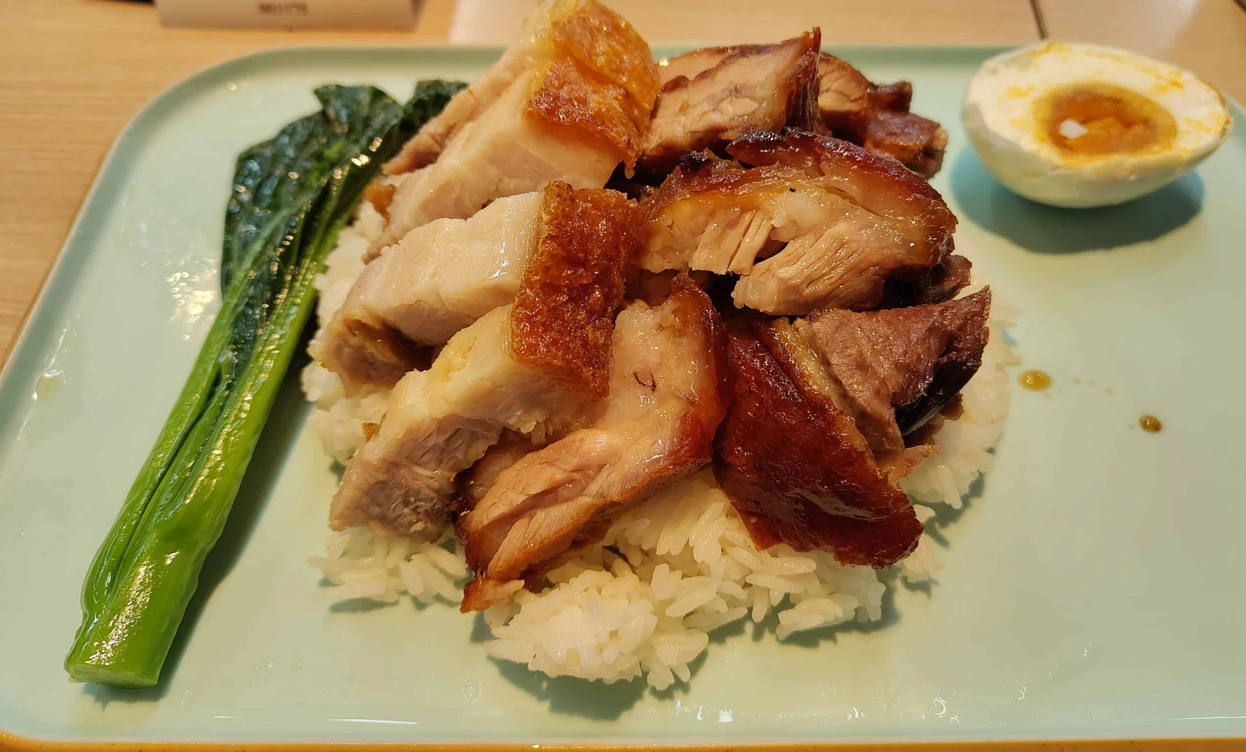 Hong Kong four treasures rice with roast pork, roast goose, egg, and greens