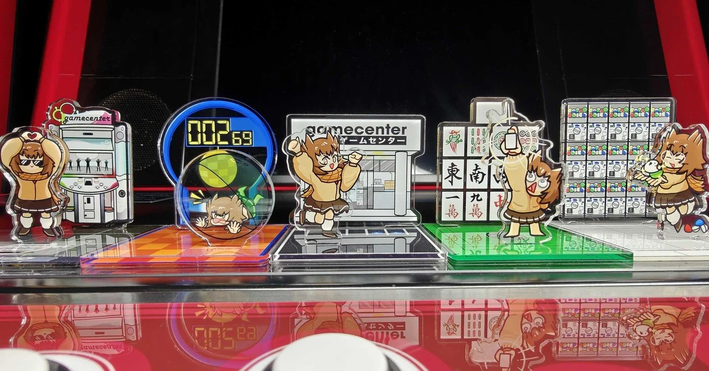 New acrylic standees are available for sale at Gamecenter, featuring 100 Yen Life's mascot, OvOchan! Collect them all! (Art by Braphics, https://www.braphics.com)
