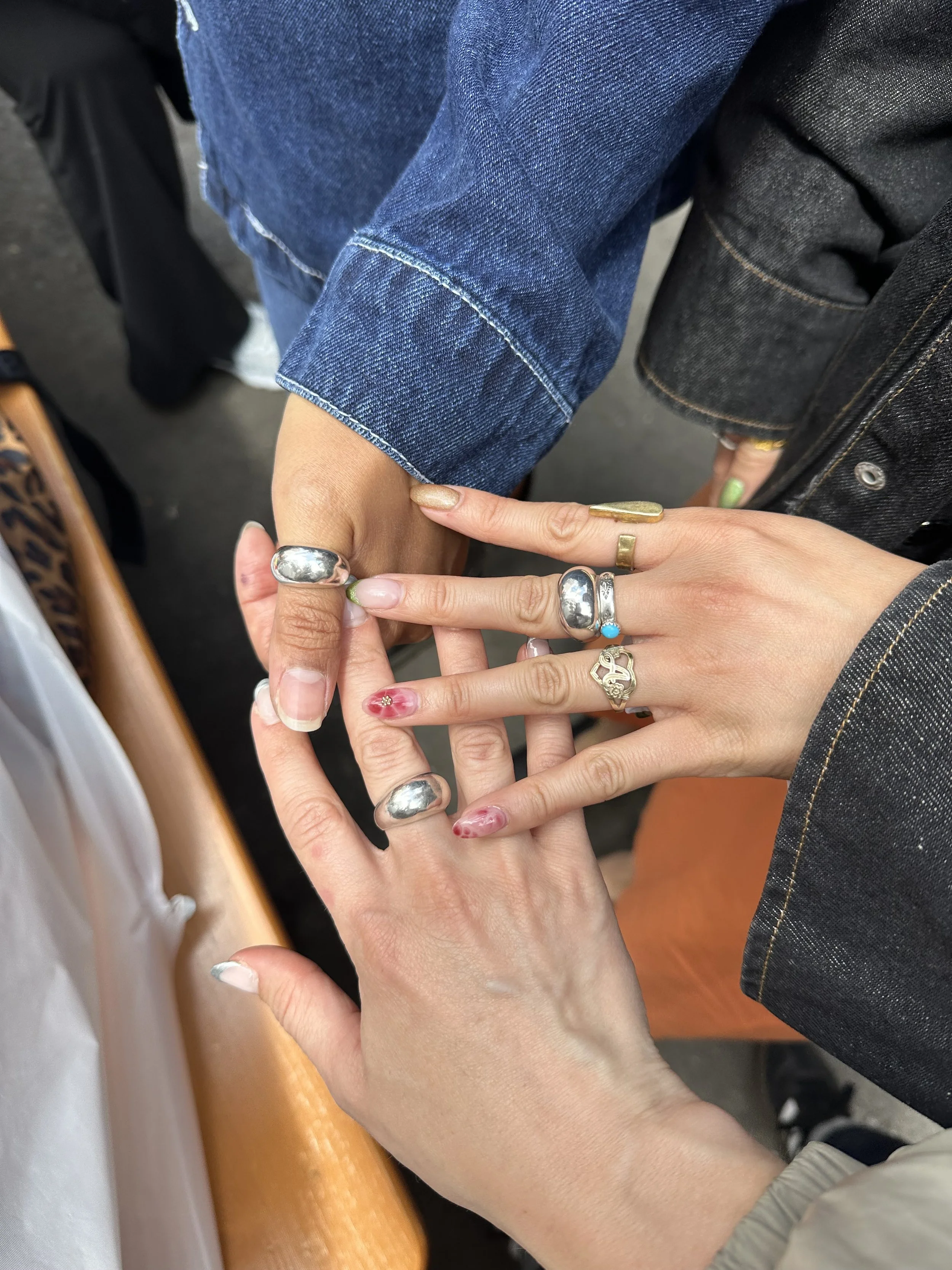 hands wearing stacked sterling silver rings including the reflection ring