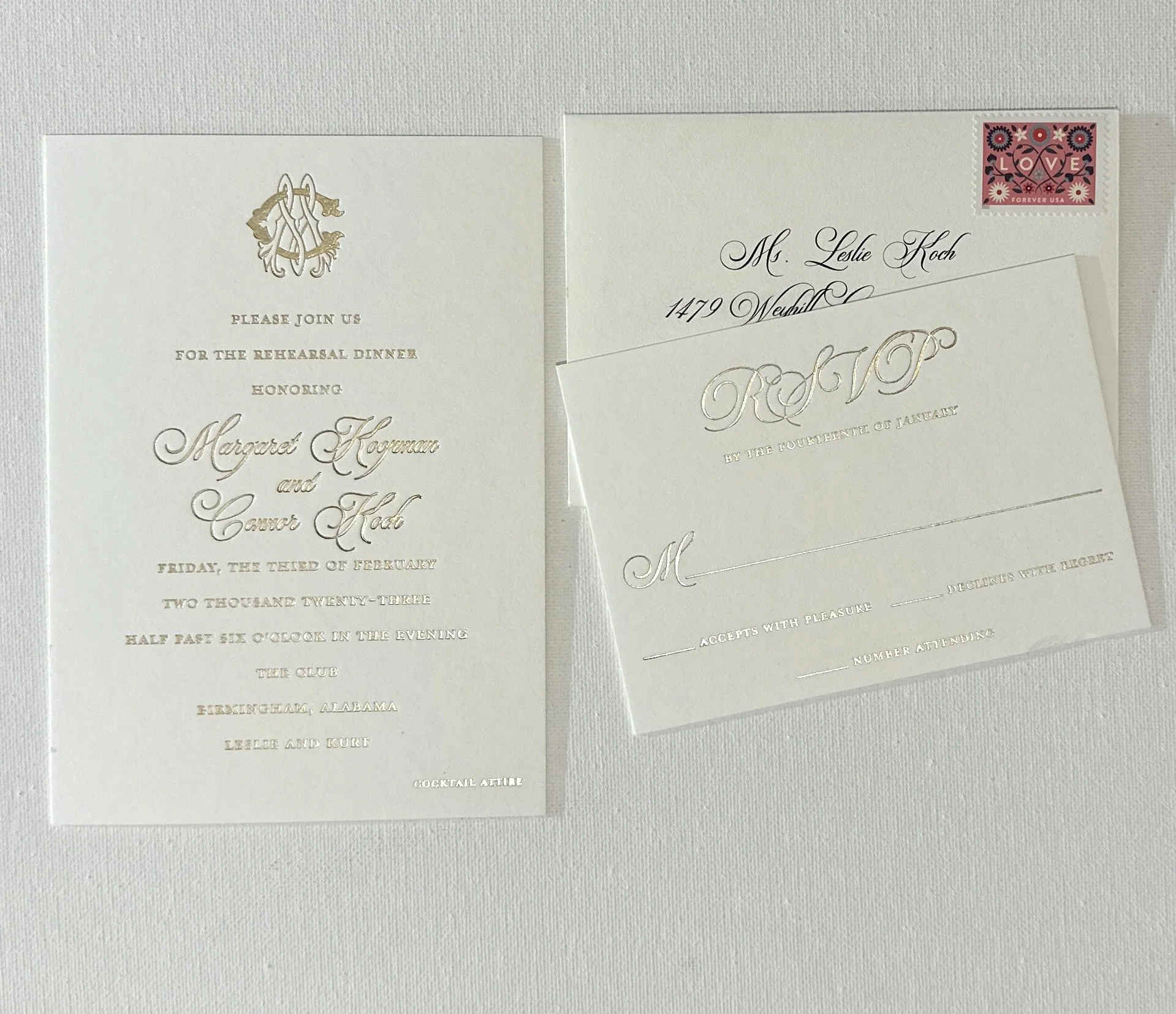 Wedding invitation, RSVP card, and envelope with a stamp, all in elegant white and gold design for a wedding celebration.