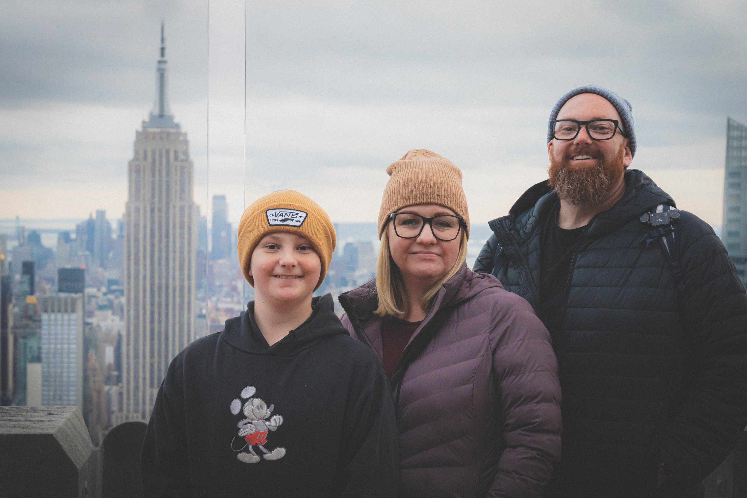 Preston, Kim, and Wesley of version 55.71 in New York City in front of the iconic Empire State Building
