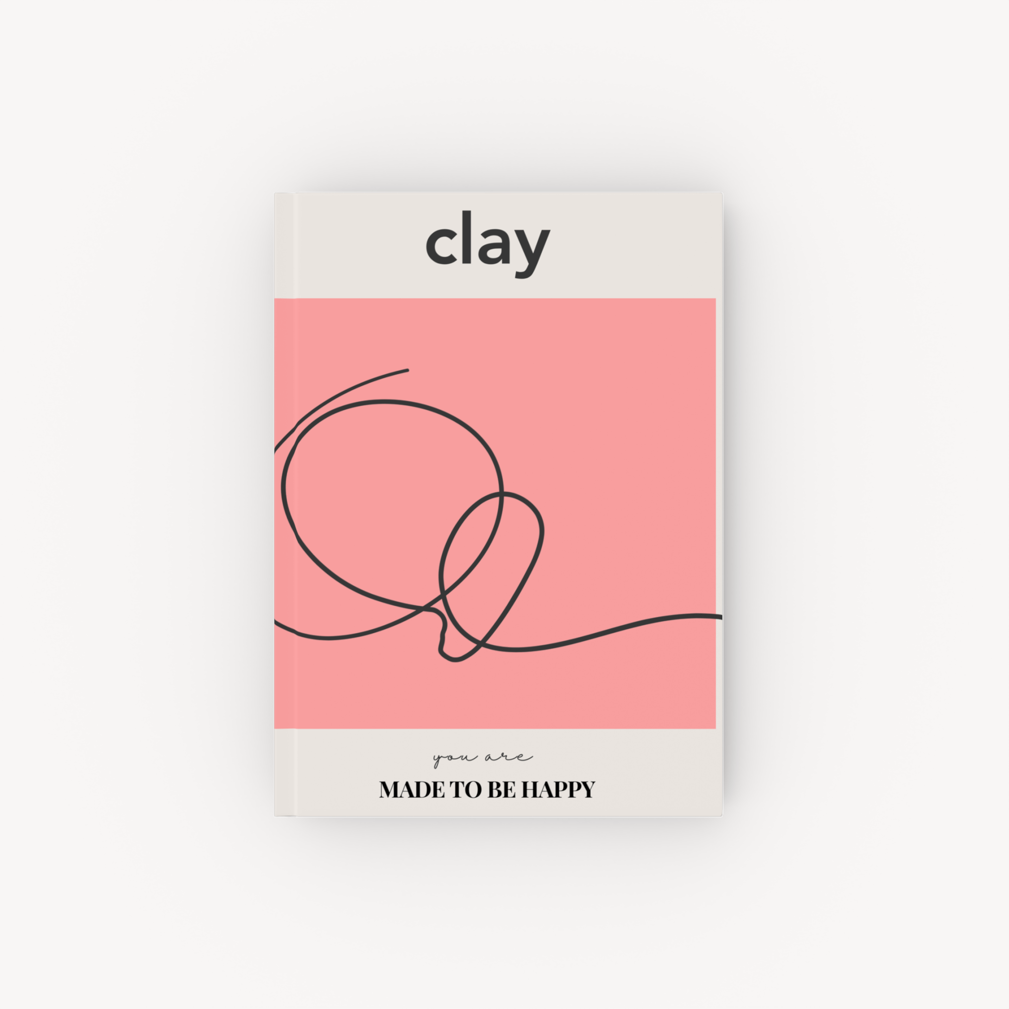 Pink-and-cream hardcover notebook titled Clay with an abstract black line design.