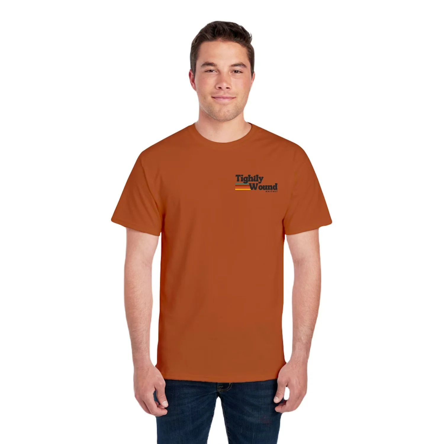 Man wearing a burnt orange colored Tightly Wound Knitwit t-shirt with a small logo on the front chest featuring retro stripes.