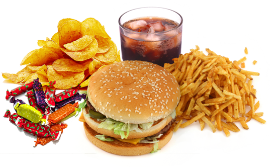 A meal with potato chips, assorted candies, a cheeseburger with lettuce, tomato, and pickles, a glass of soda with ice, and a pile of French fries.