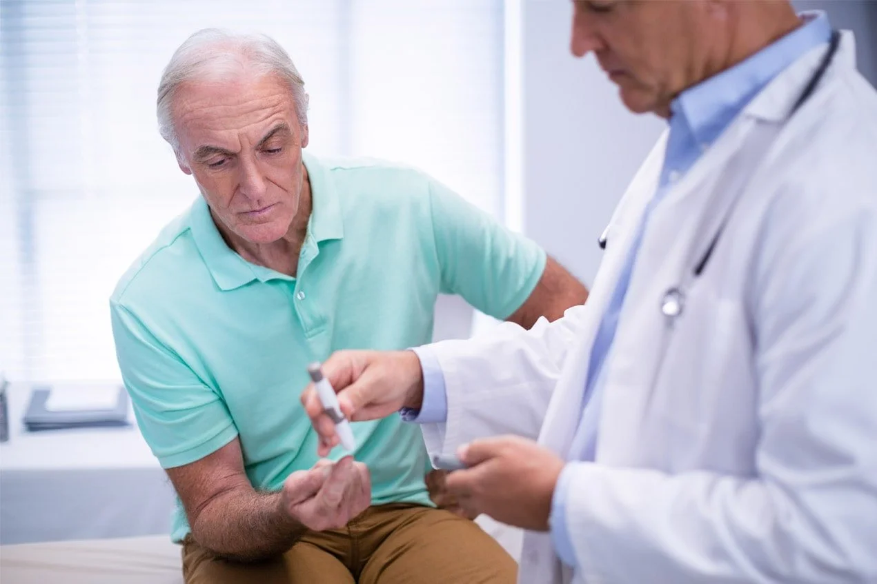 A doctor caring for an older patient in a medical office