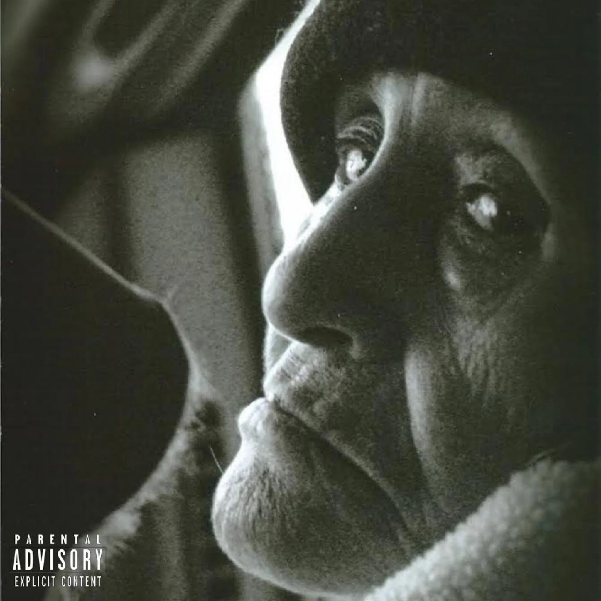 A black and white close-up photo of a person's face with a pensive expression, resting their chin on their hand.