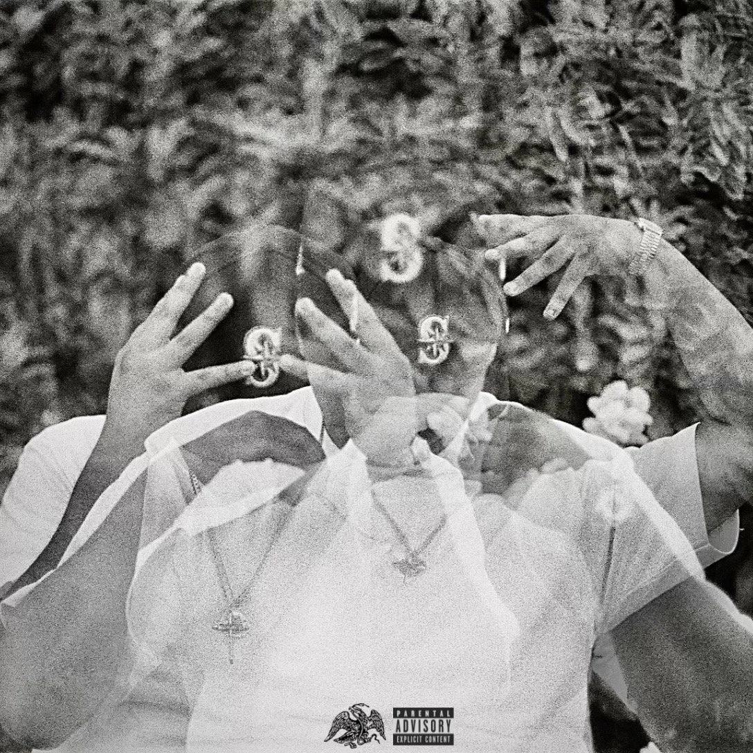 Black and white image of multiple overlaid photographs of a person holding a mirror in front of their face. The person is wearing jewelry, including necklaces and rings, and has short hair. The background features dense foliage.