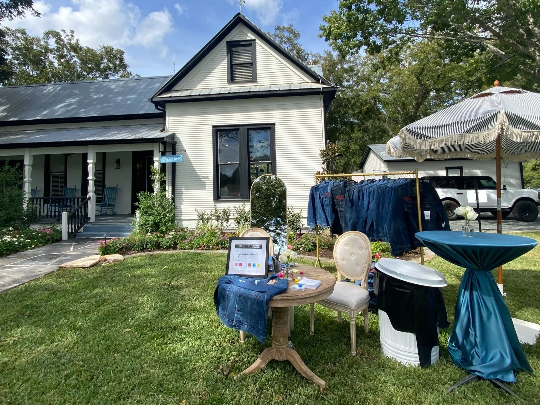 Hand painting denim jackets at an event in Houston