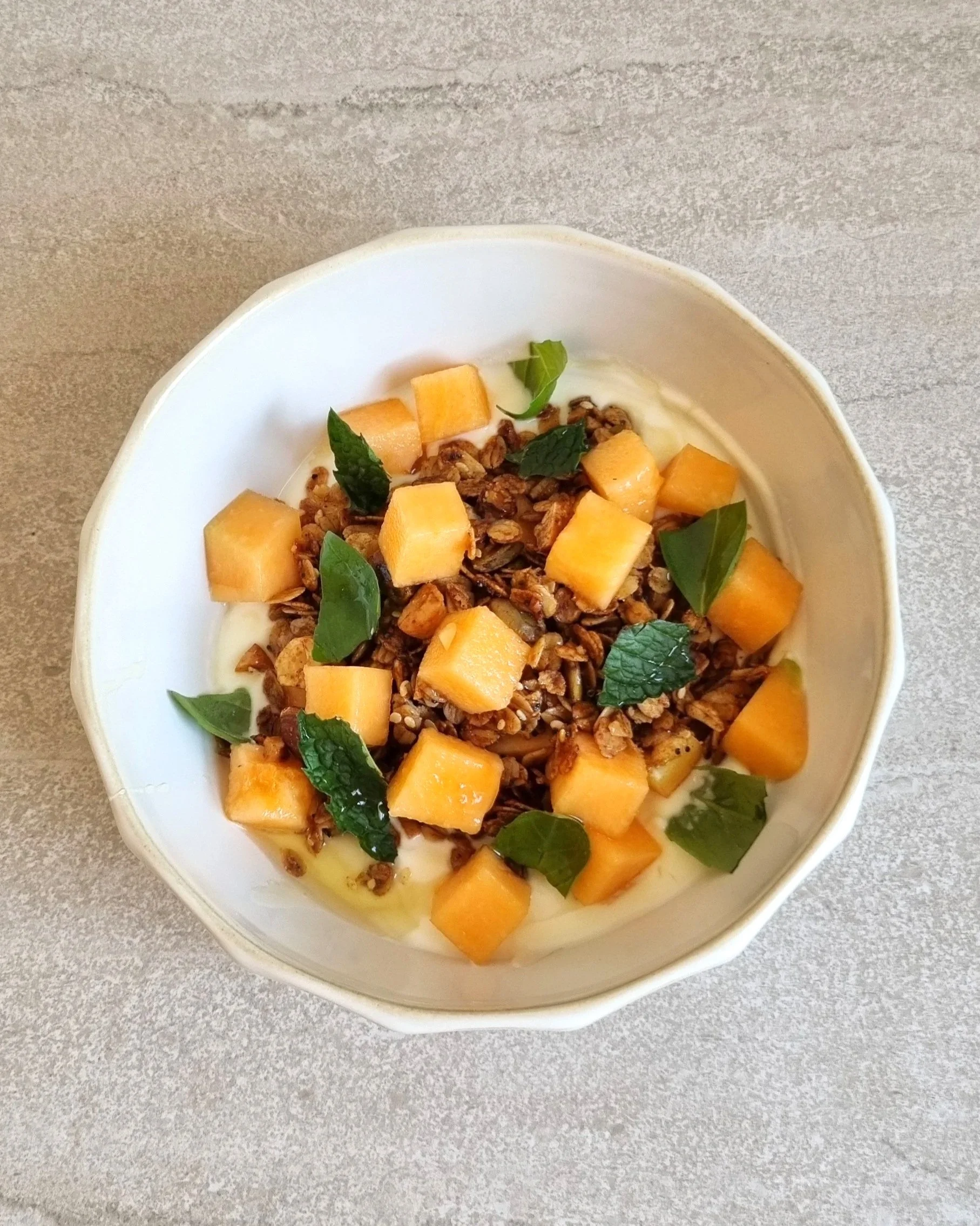 Homemade granola, rockmelon, yoghurt & breakfast bowl