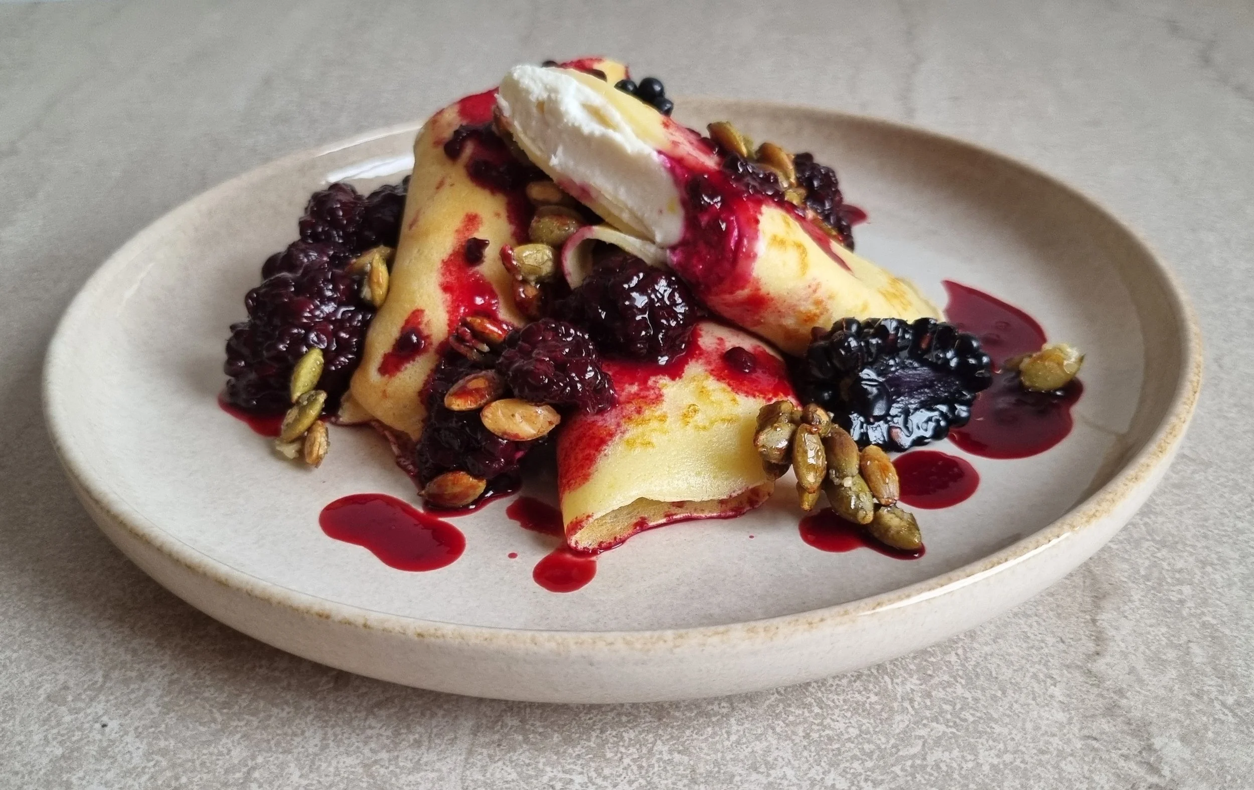 Lemon ricotta crepes with blackberry compote