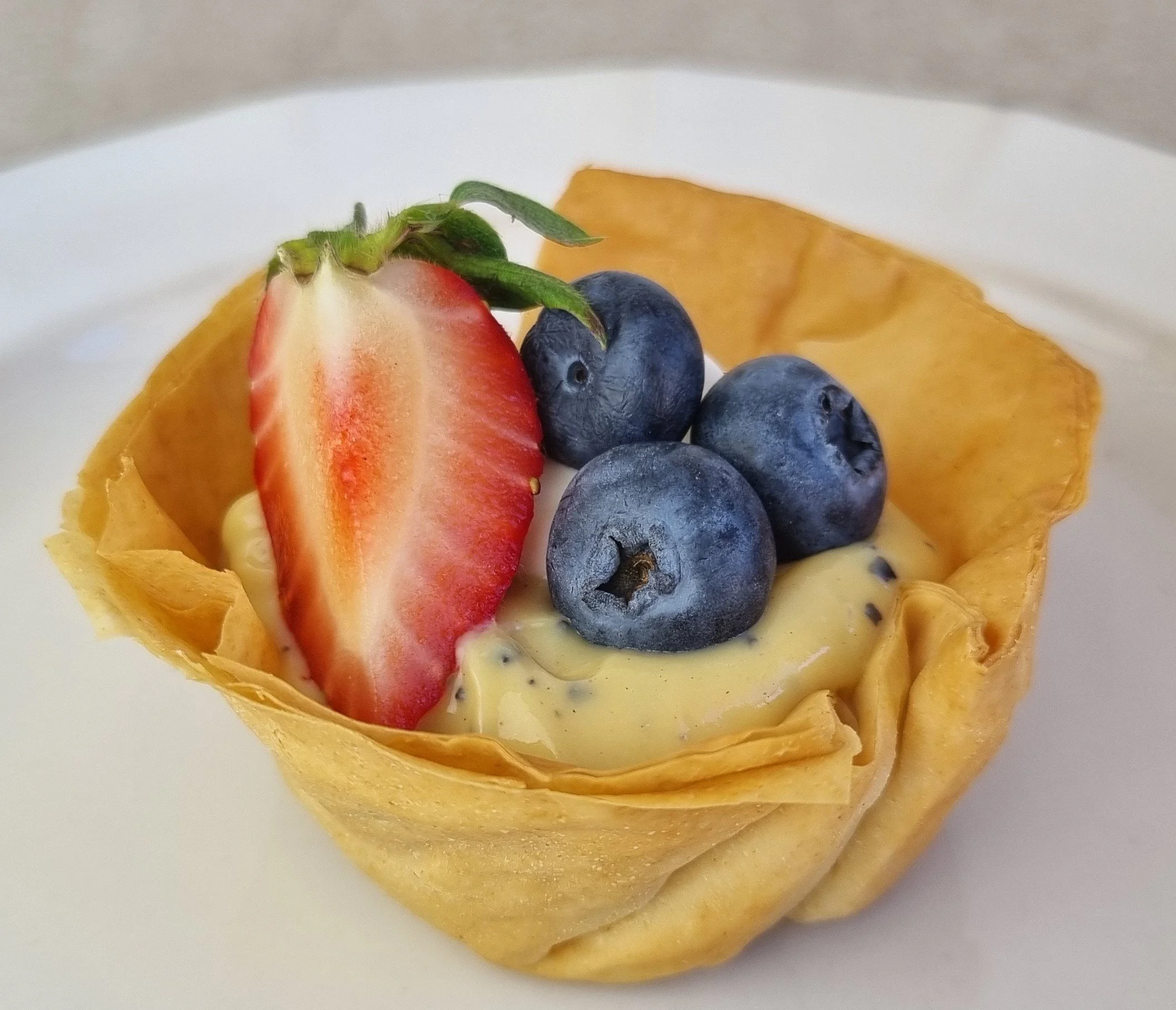 Passionfruit curd tarts with berries