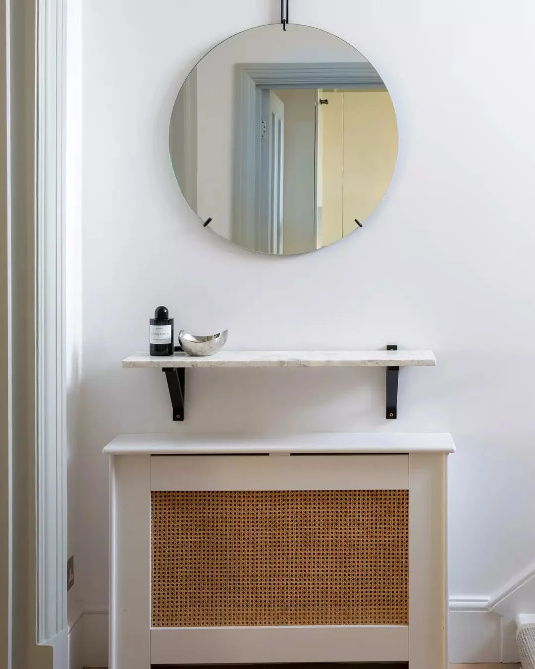 A hallway shot at our Kensington project. Utilising small spaces to add functionality whilst maintaining the contemporary and sophisticated style throughout! 👆🏼

The custom terrazzo shelf and rattan unit conceal the radiator.&nbsp; Both adding the 