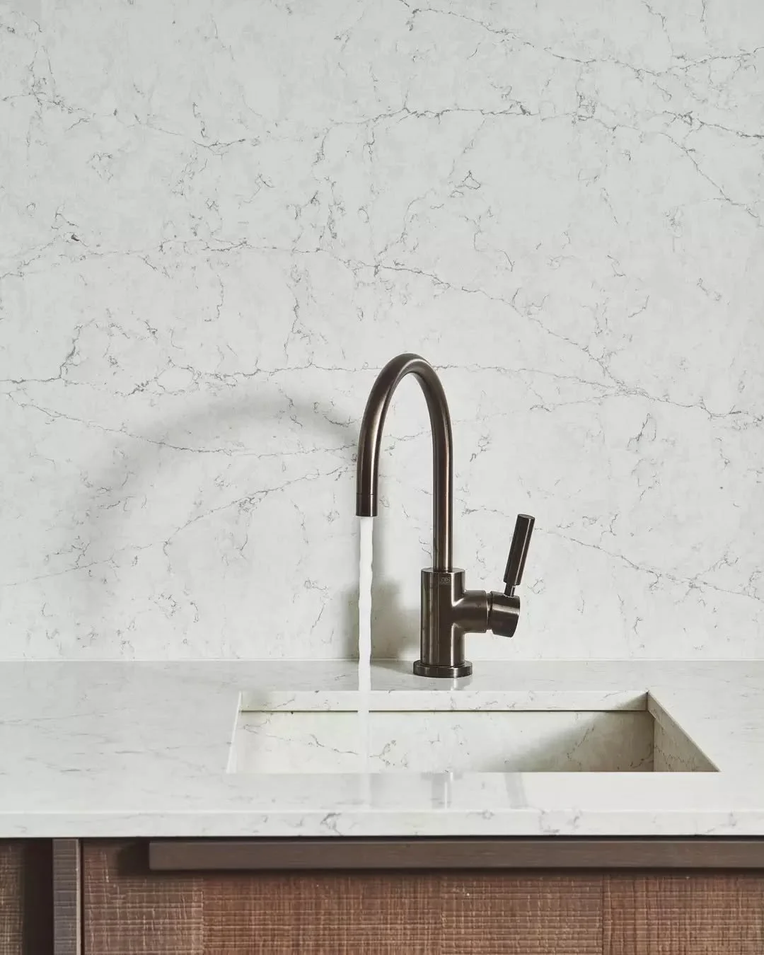 Who said office kitchens can't have character? We opted for sturdy Consentino worktop and backsplash in combination with the bronze tap and dark timber units, curating a perfectly sophisticated and inviting kitchen for both staff &amp; visitors at @b