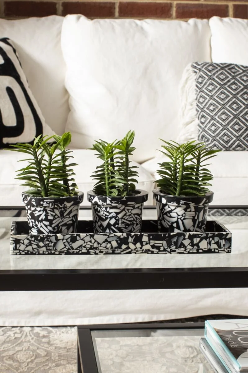 A black and white set of pots with a tray.
