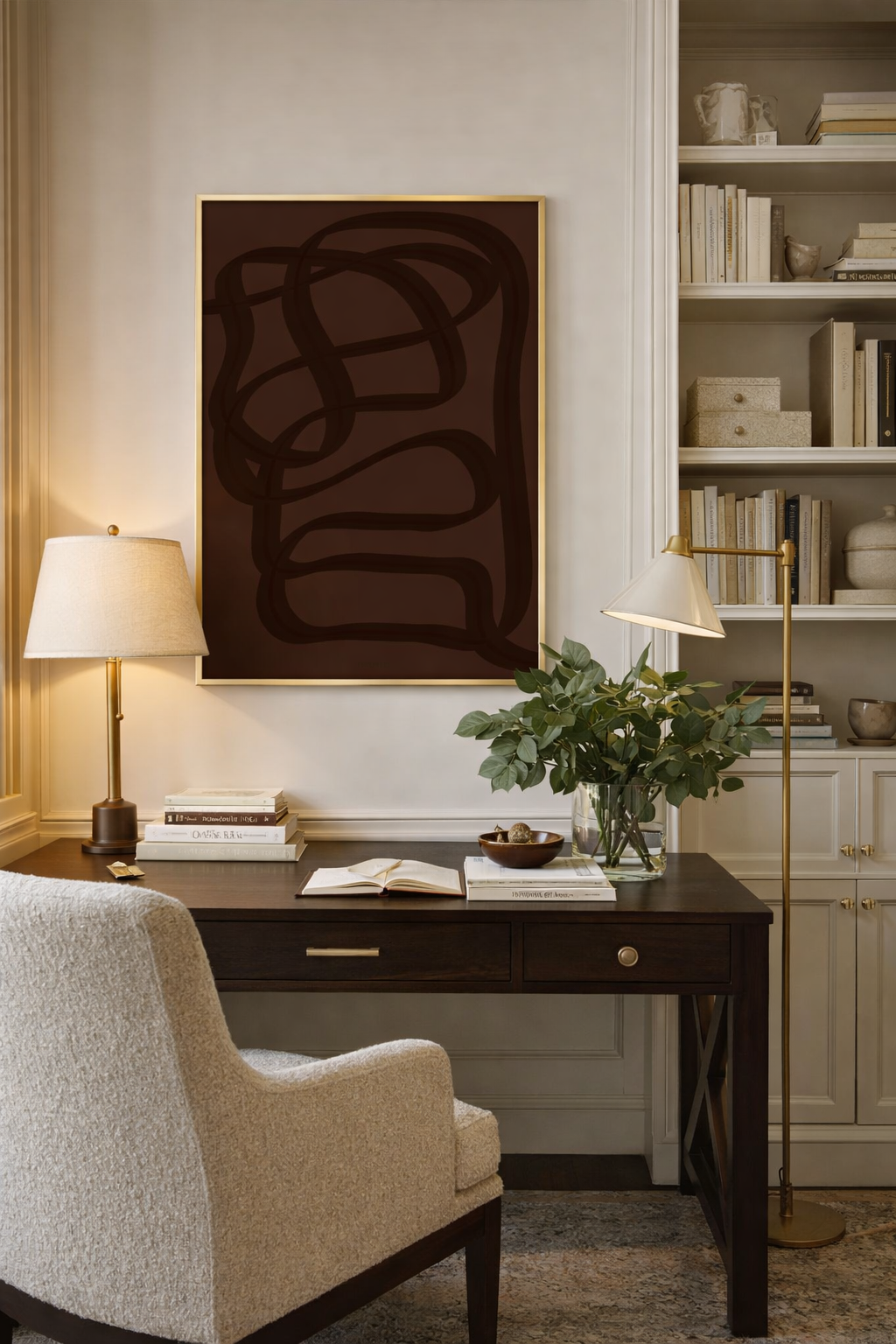 A home office featuring a deep brown print with a gold frame.