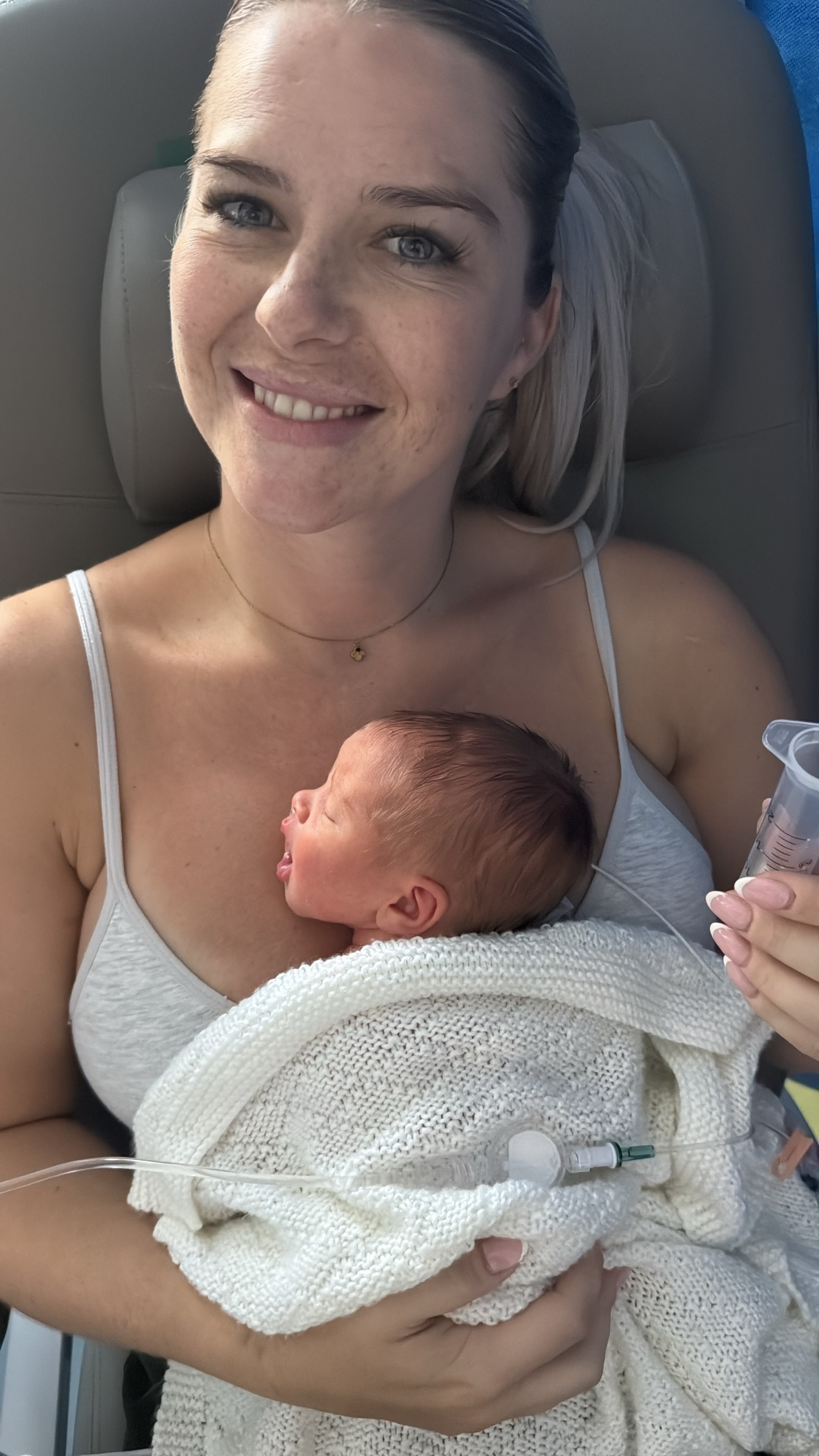 A new mum with her premature baby feeding through a tube