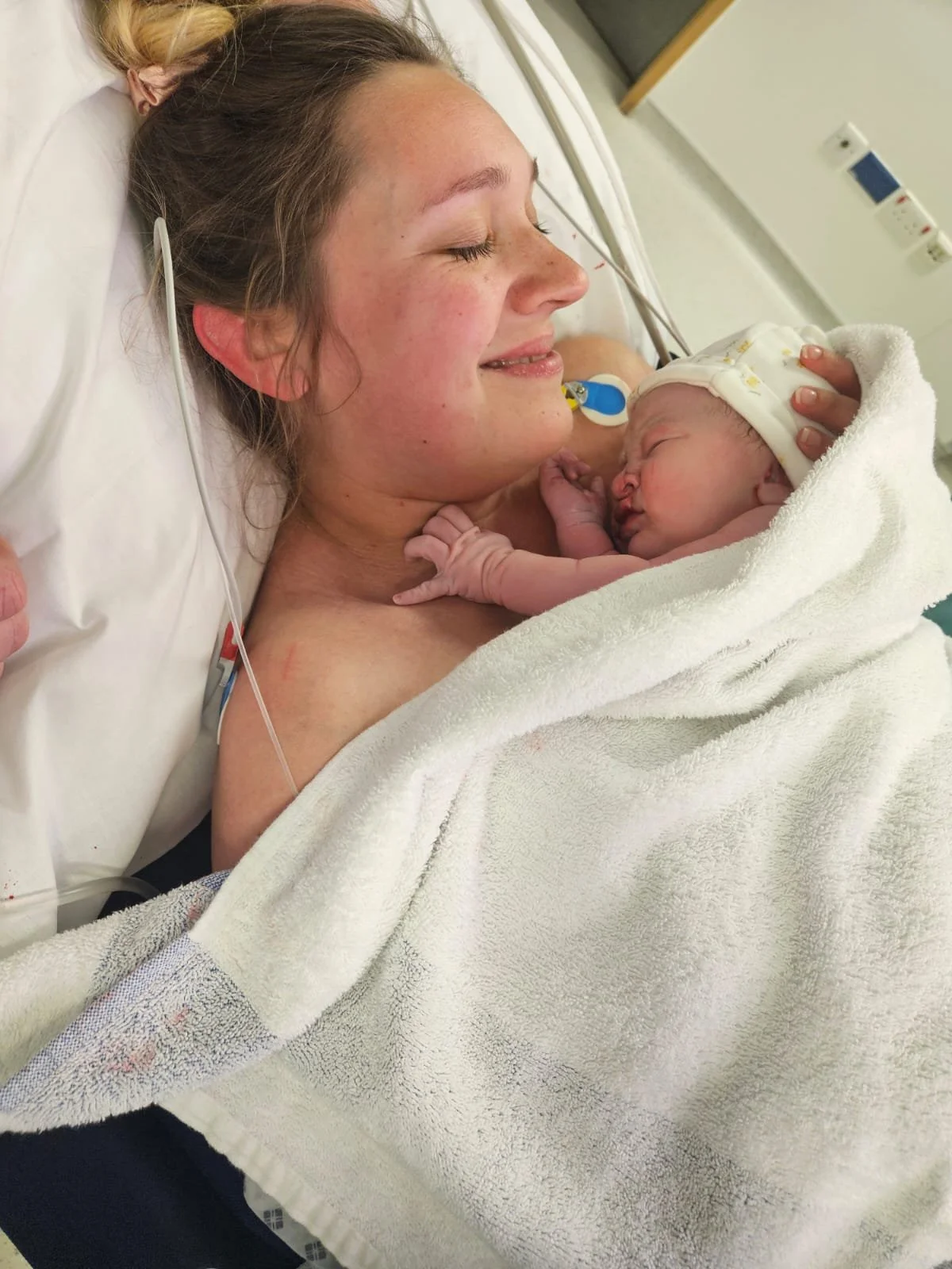 A new mum with a baby on her chest after giving birth