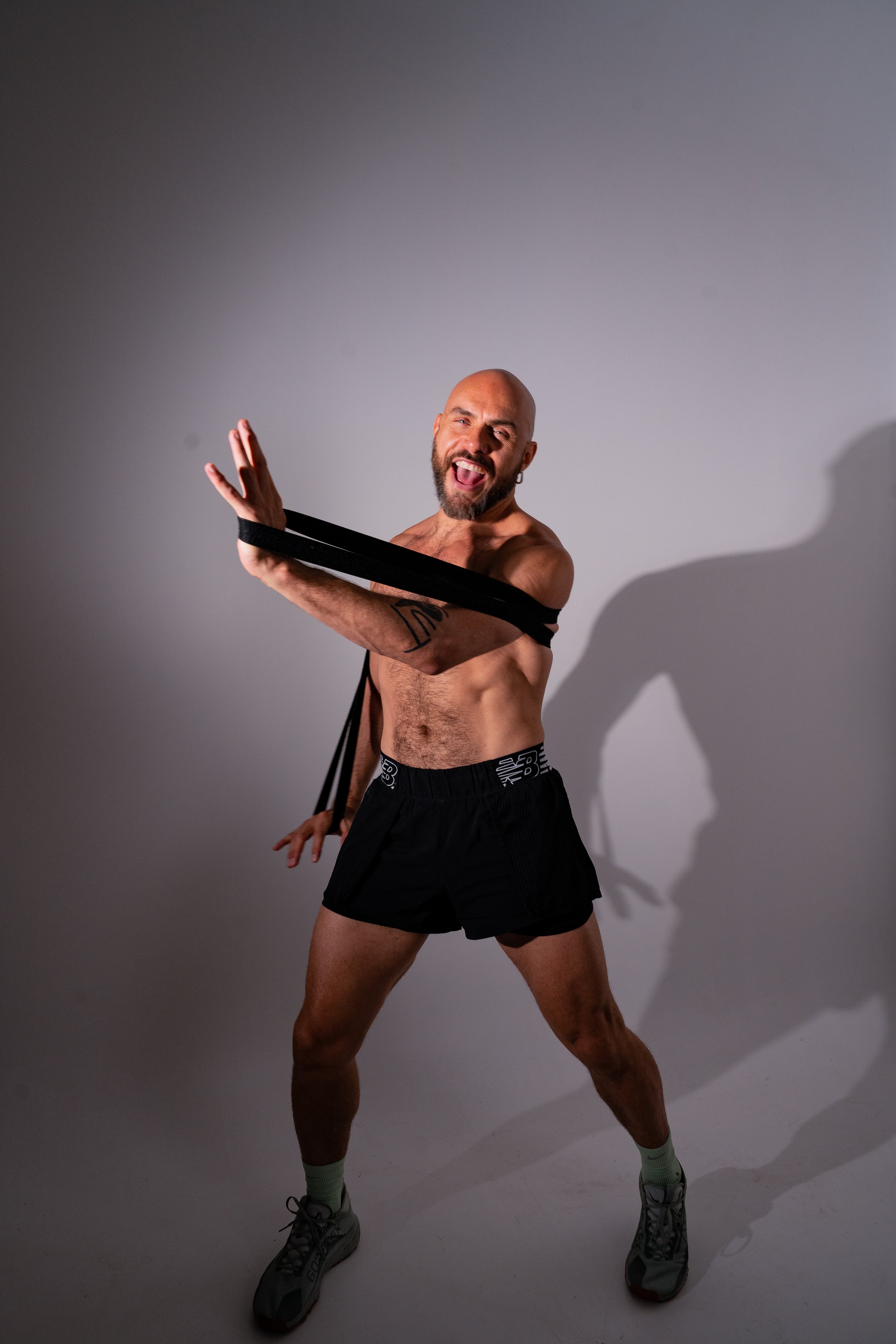 Man exercising with resistance bands in a studio
