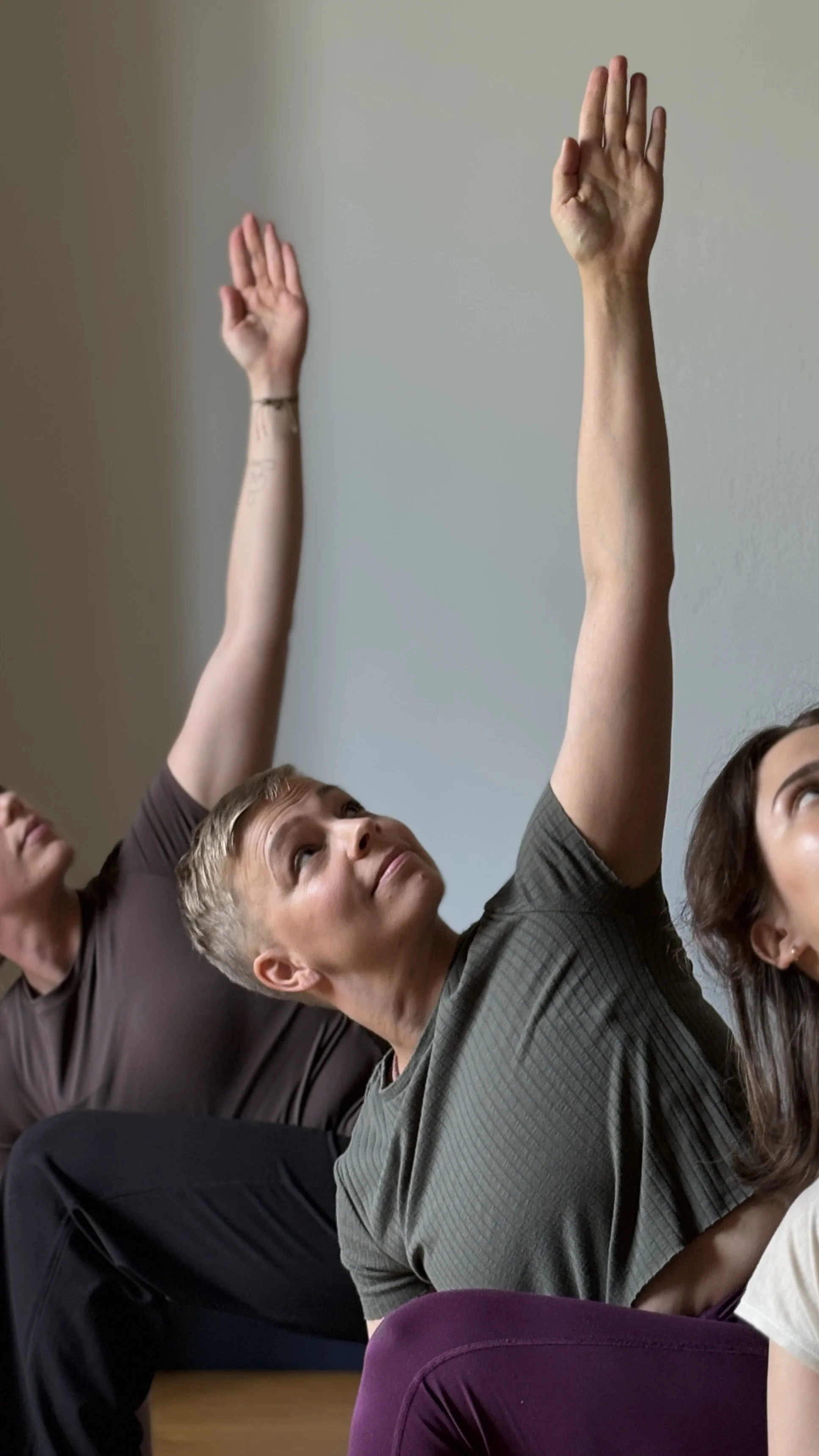 tanja reaching up in a twisted yoga pose.jpeg