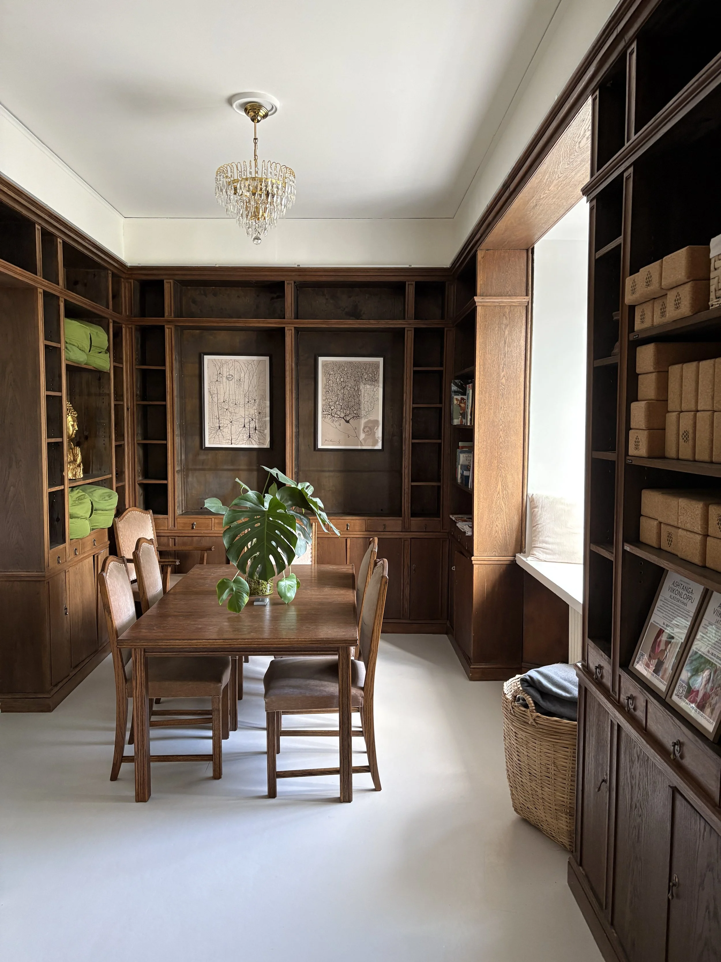 a wood table inside a library with a bright window