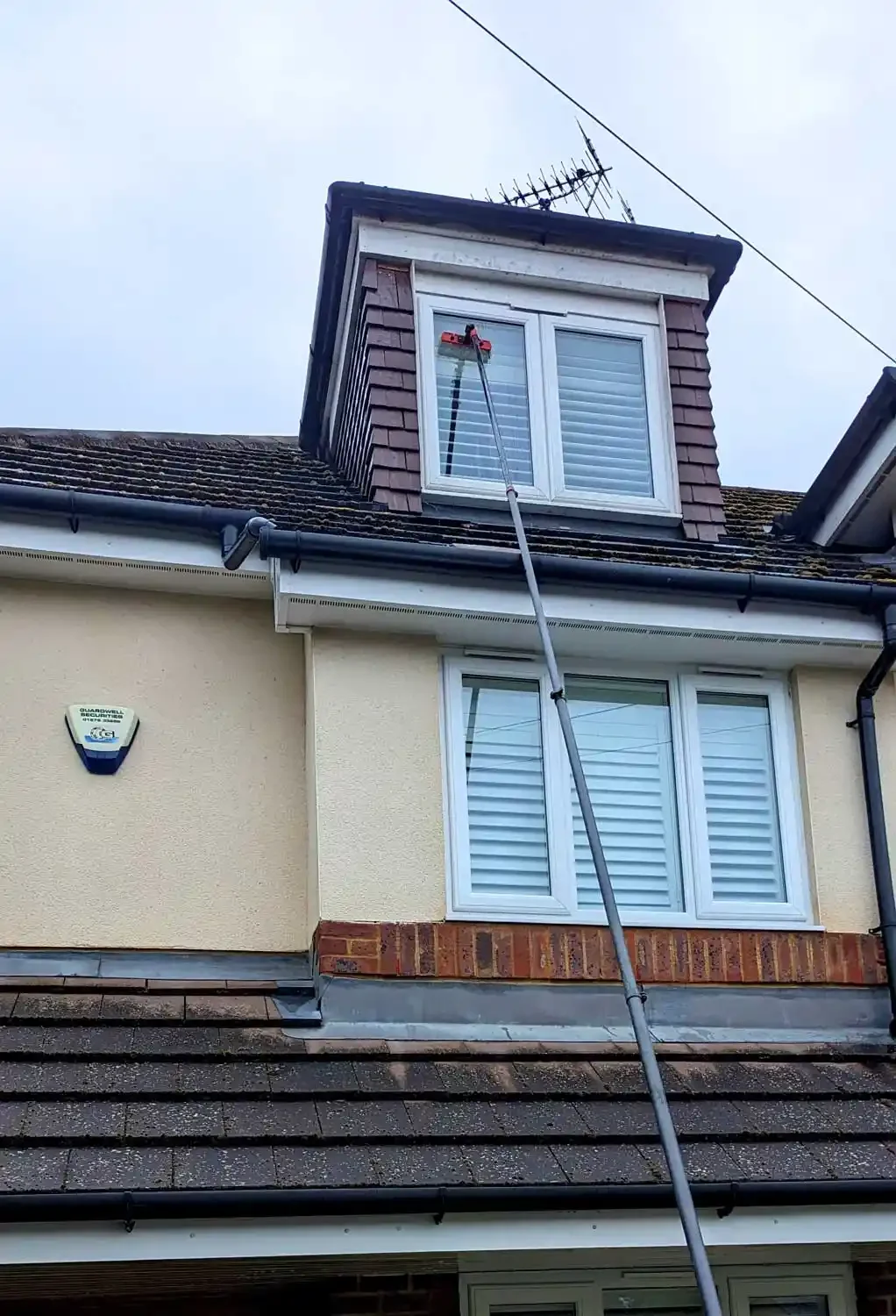 A top floor window being cleaned by brilliant sheen cleaning