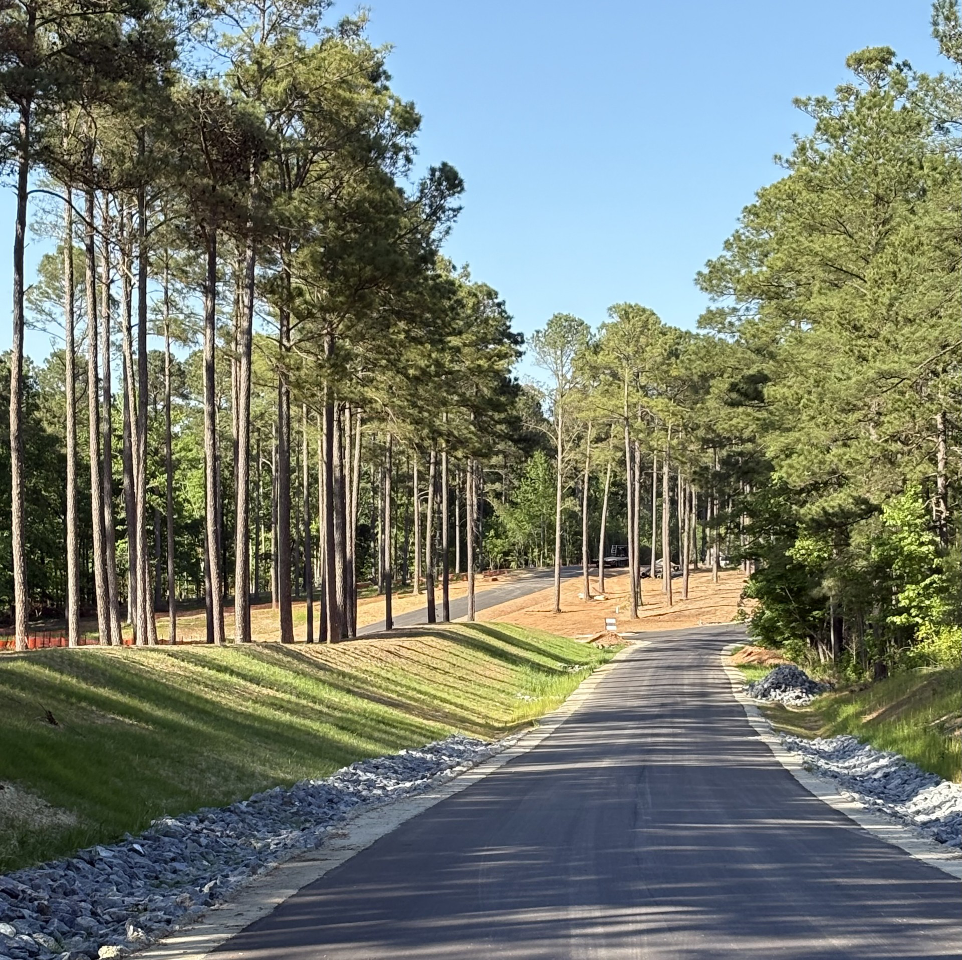 Newly constructed access road with erosion control measures by MEC in a wooded site