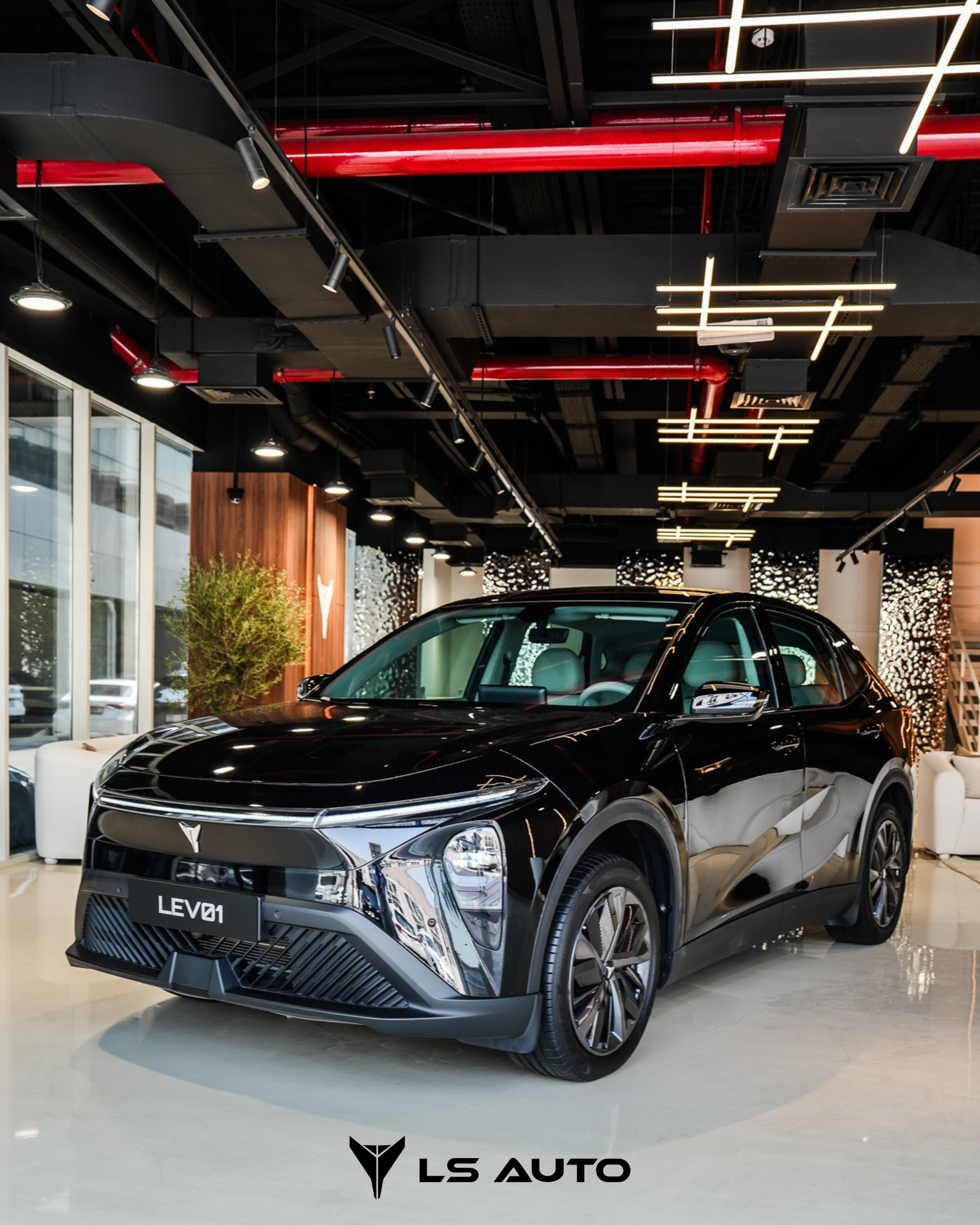 Black LEV01 electric SUV on display inside a modern showroom with white floors, large windows, and contemporary lighting fixtures.