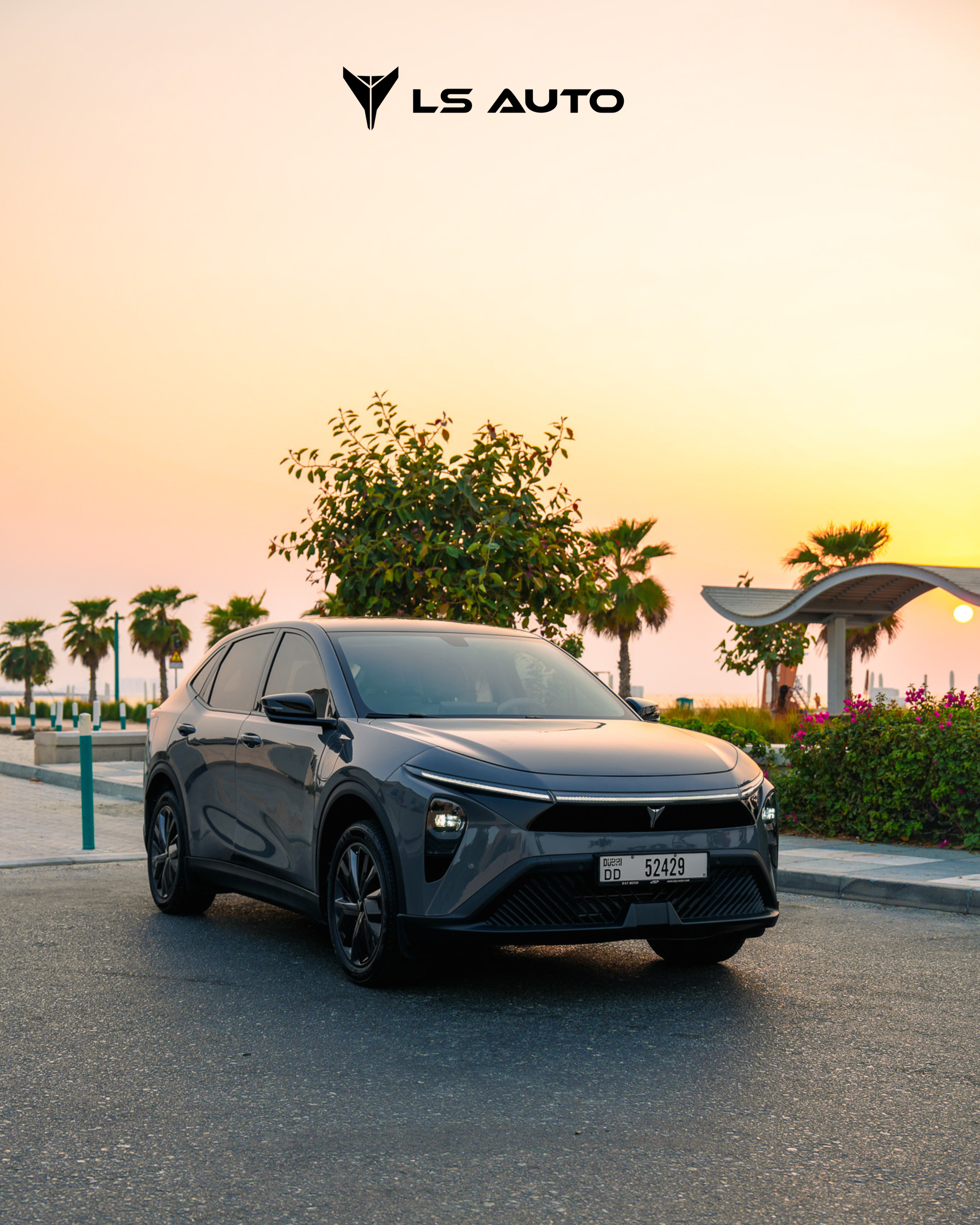 Grey LEV01 electric vehicle parked near a park with palm trees, a pavilion, and a sunset in the background, with the logo 'LS Auto' at the top.