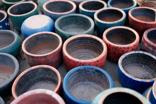 A collection of colorful ceramic pots arranged on a surface.