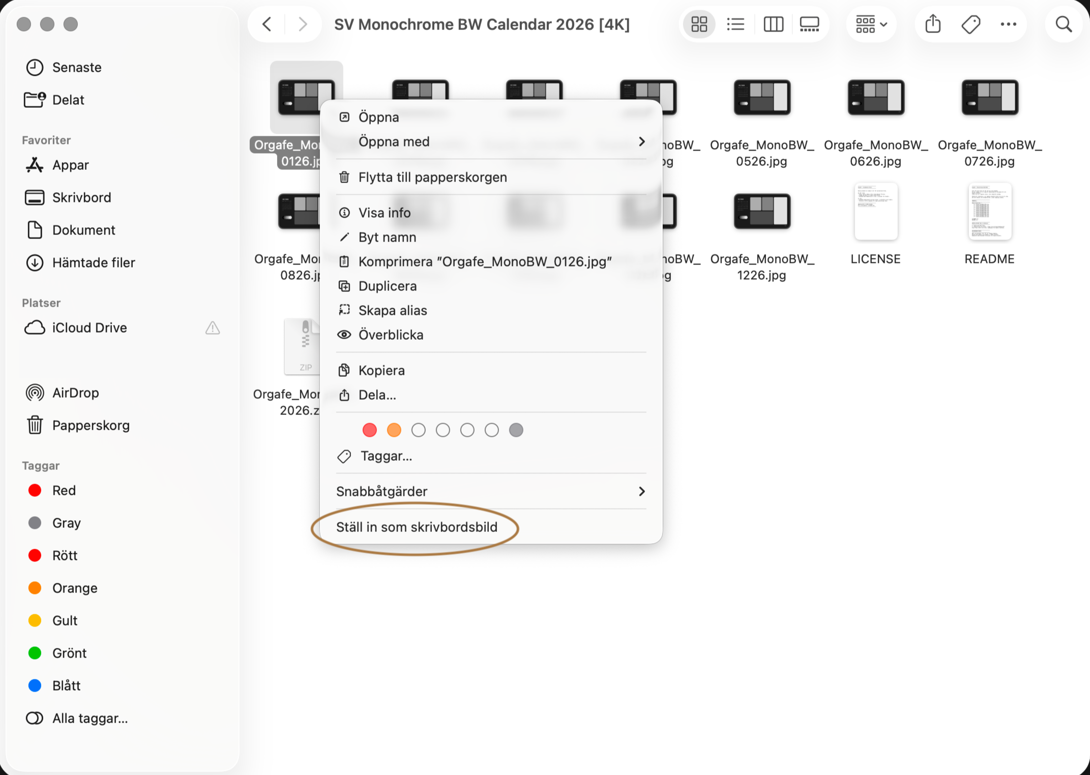 En datorskärm med en mapp av bilder och filer för en kalender. Den visar en högerklicksmeny med alternativ för att markera bilden som skrivbordsbakgrund.