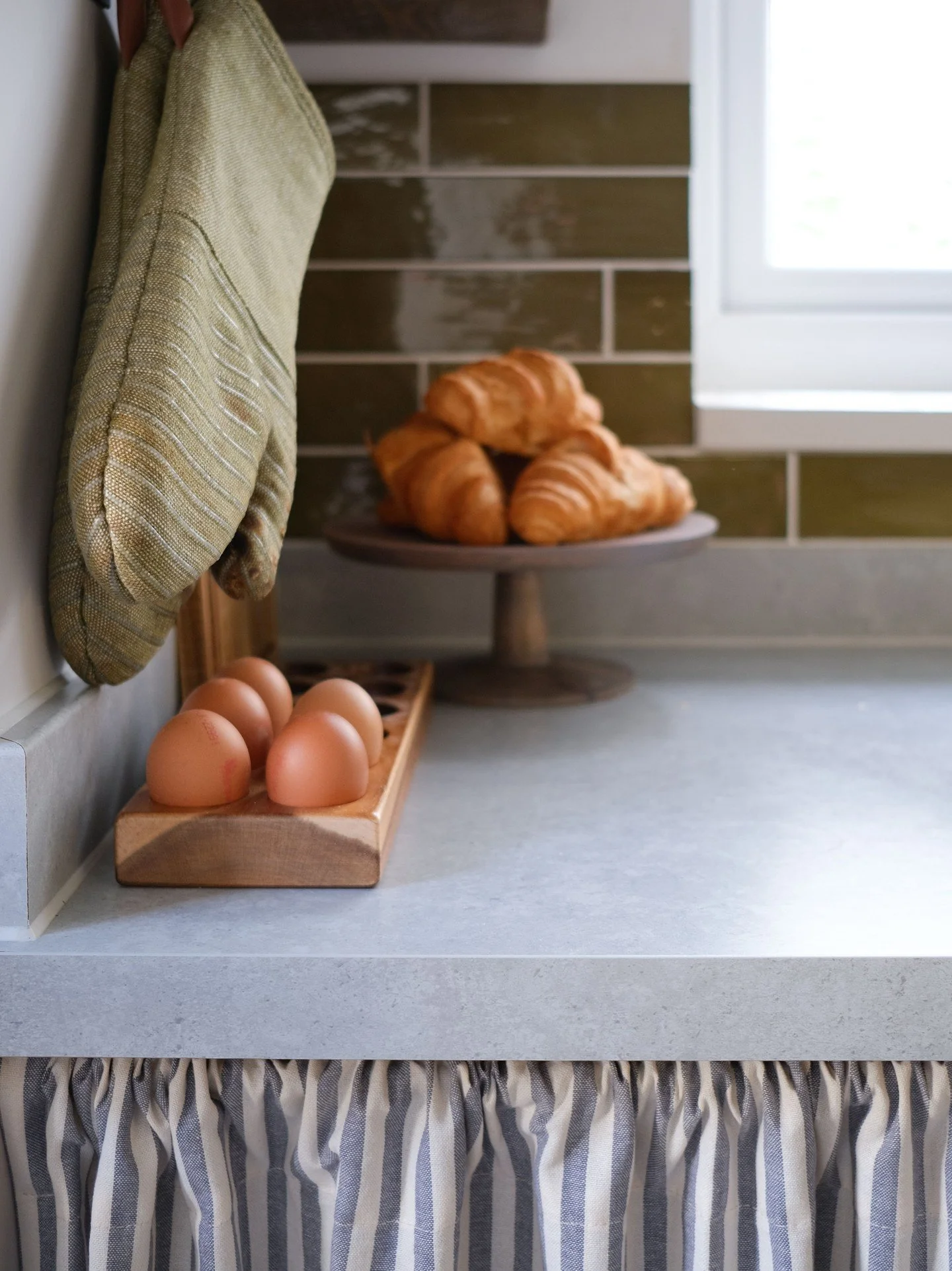 A light touch to a kitchen, that won't break the bank. 
To save both waste and money, rather than rip out and replace the newly-fitted-albeit-basic cabinetry of this small apartment, we instead focused on just about everything else. By adding a cupbo