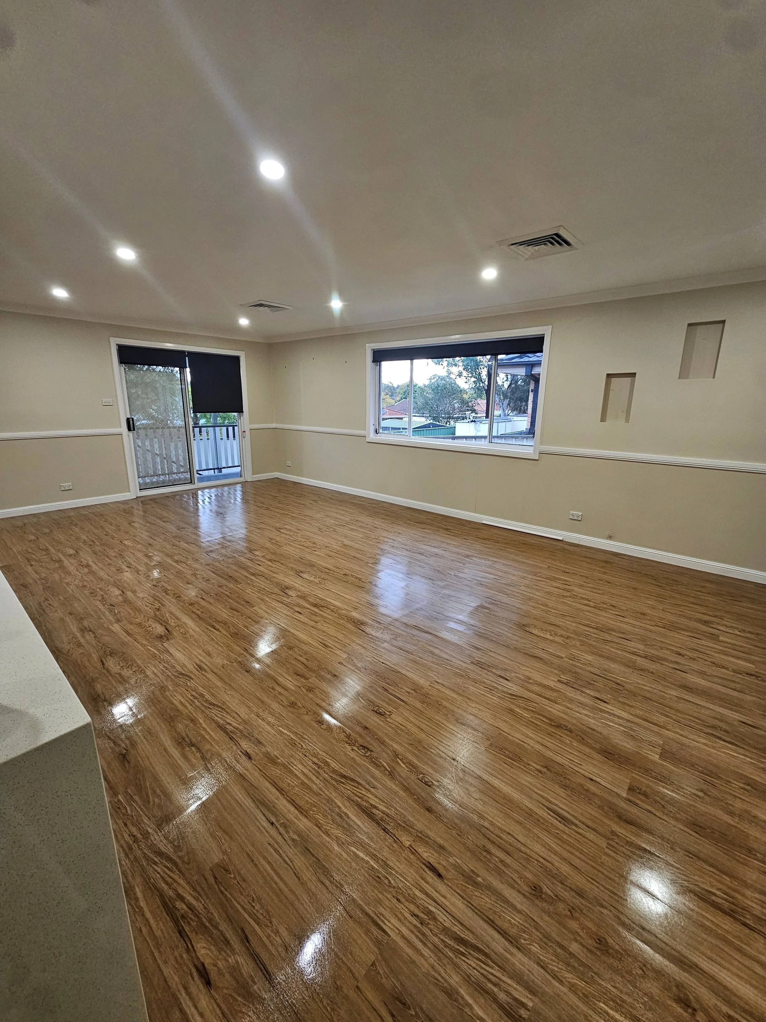 empty sparkling clean living room with island bench