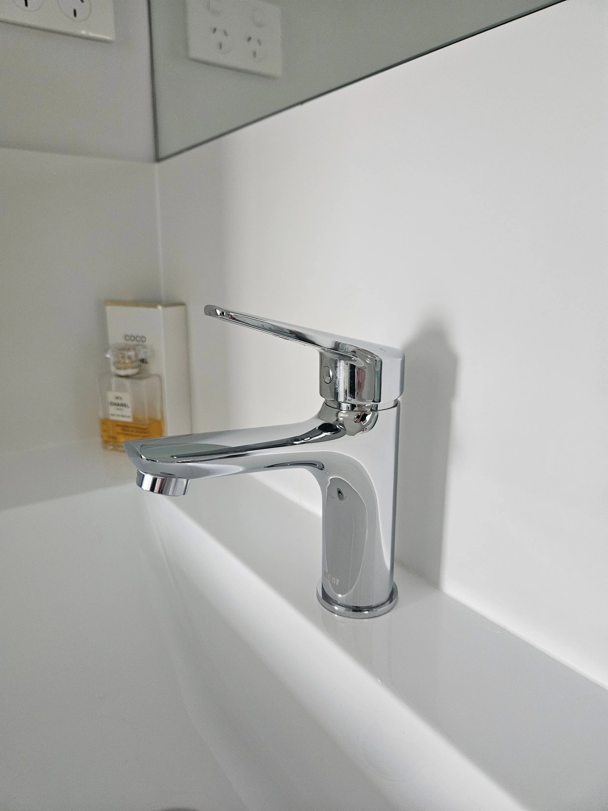 Clean and modern bathroom counter with flower and candle decor