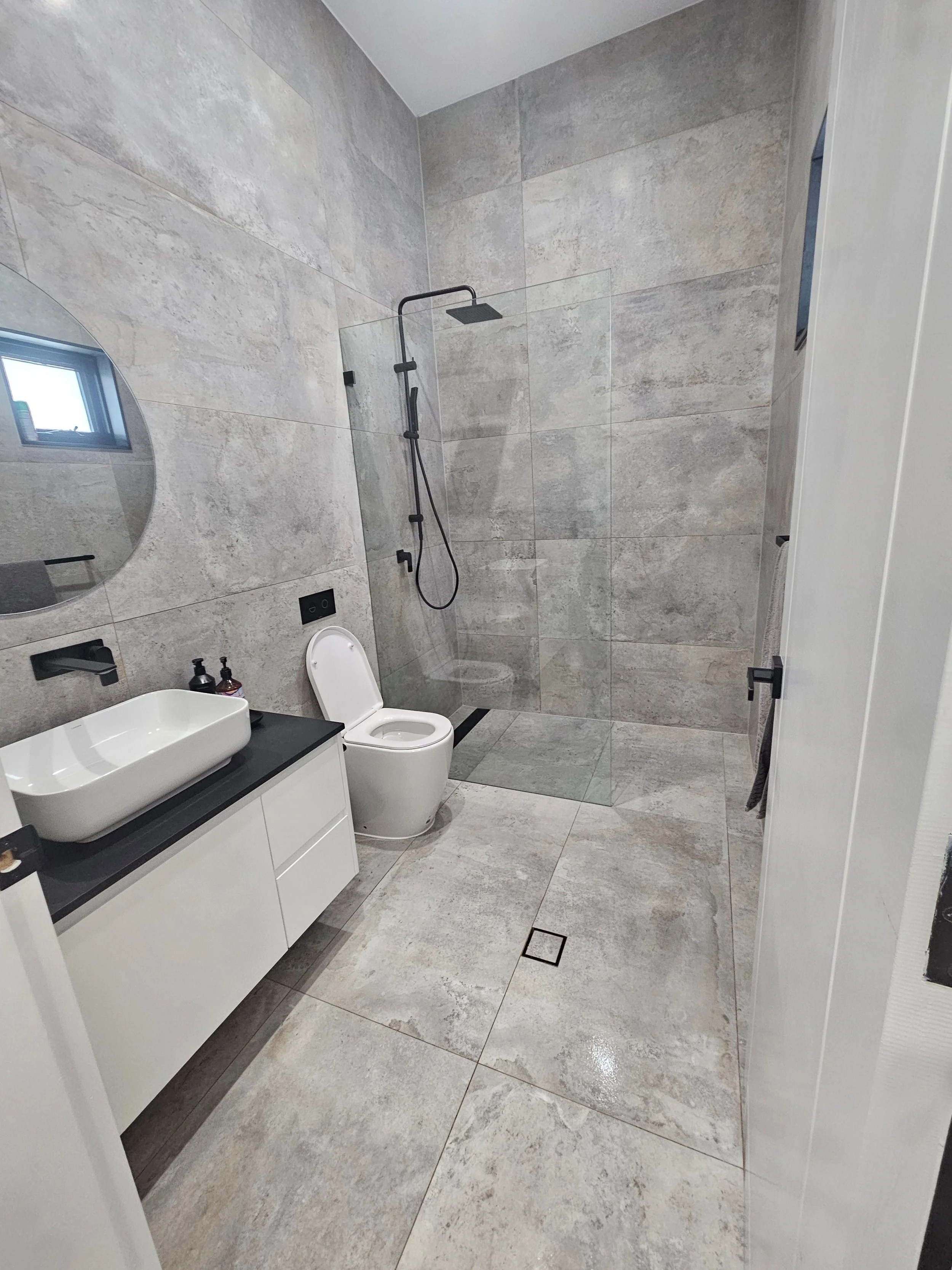 clean modern guest bathroom with black tapware