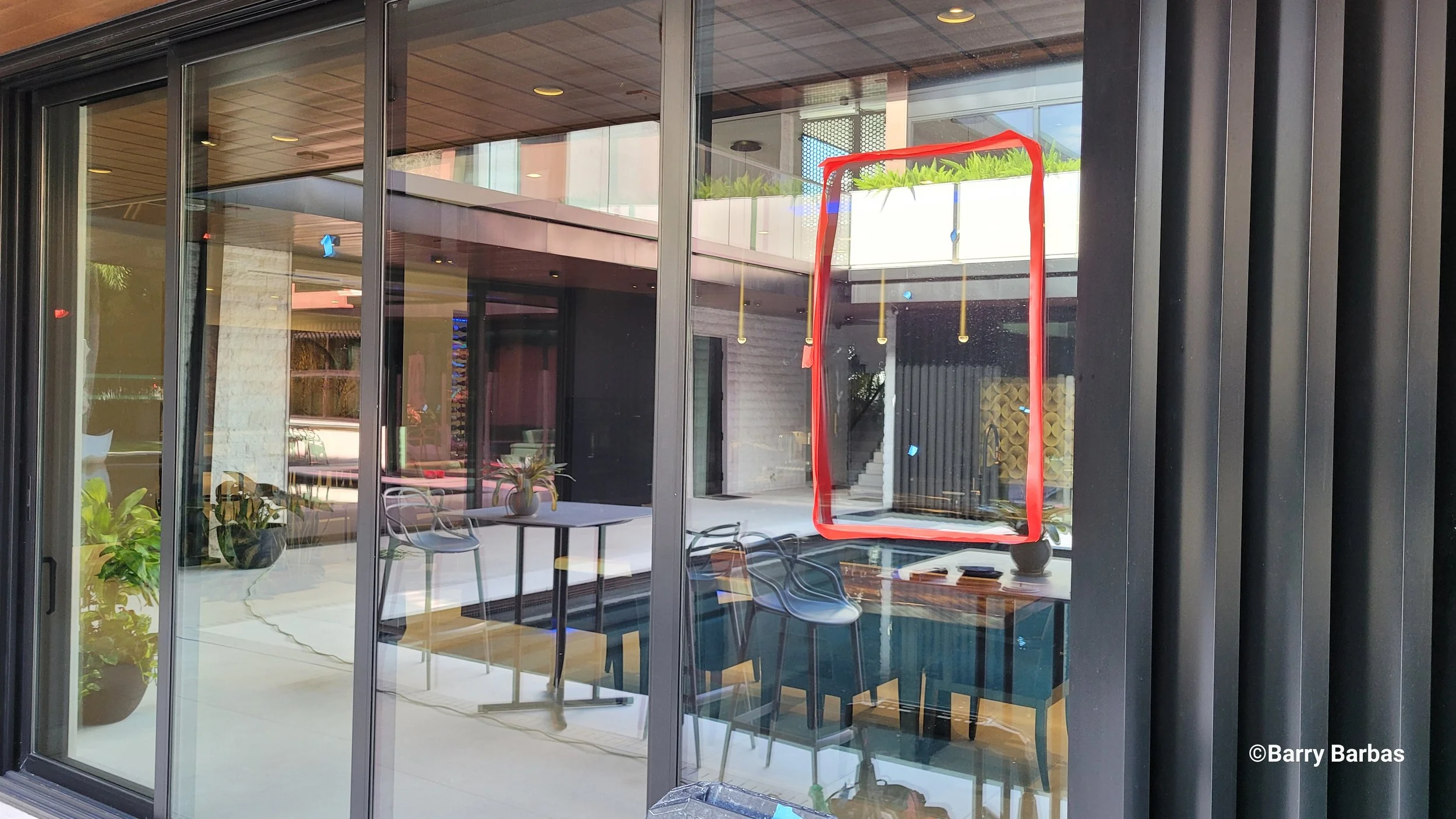 Glass Restoration Inc. crew restoring scratched glass on a Bradenton restaurant storefront — commercial glass polishing services Harbourwalk waterfront district
