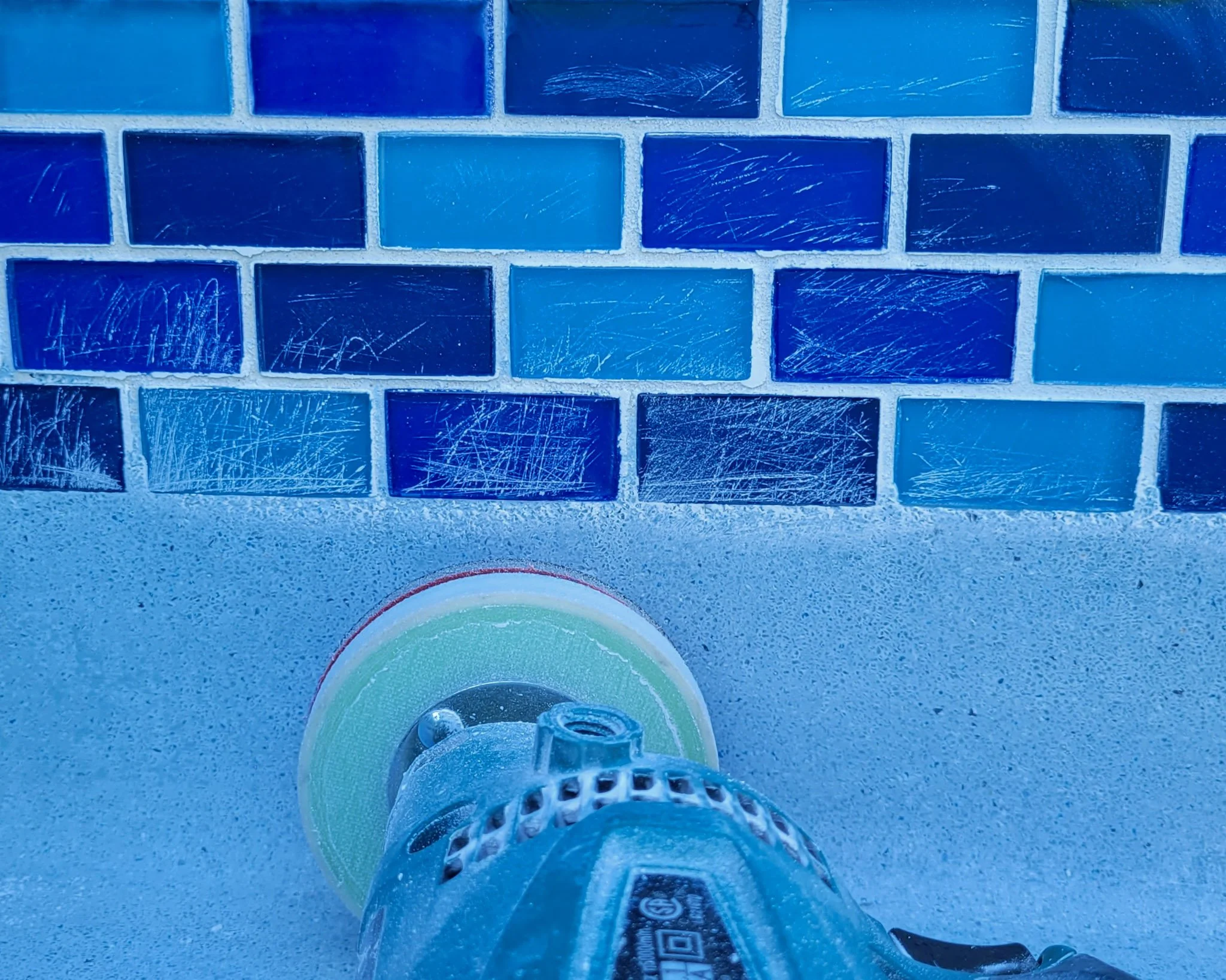 Riverview Florida new pool renovation had all the spa hot tub tile scratched. We restored it so demolition was not required.