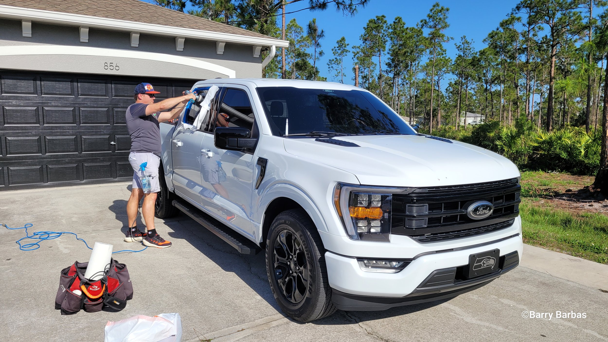 Stanton Barbas performing artisan glass scratch removal on a Ford F-150 — Glass Restoration Inc. scratch removal specialists serving classic and modern vehicle glass in Bradenton FL