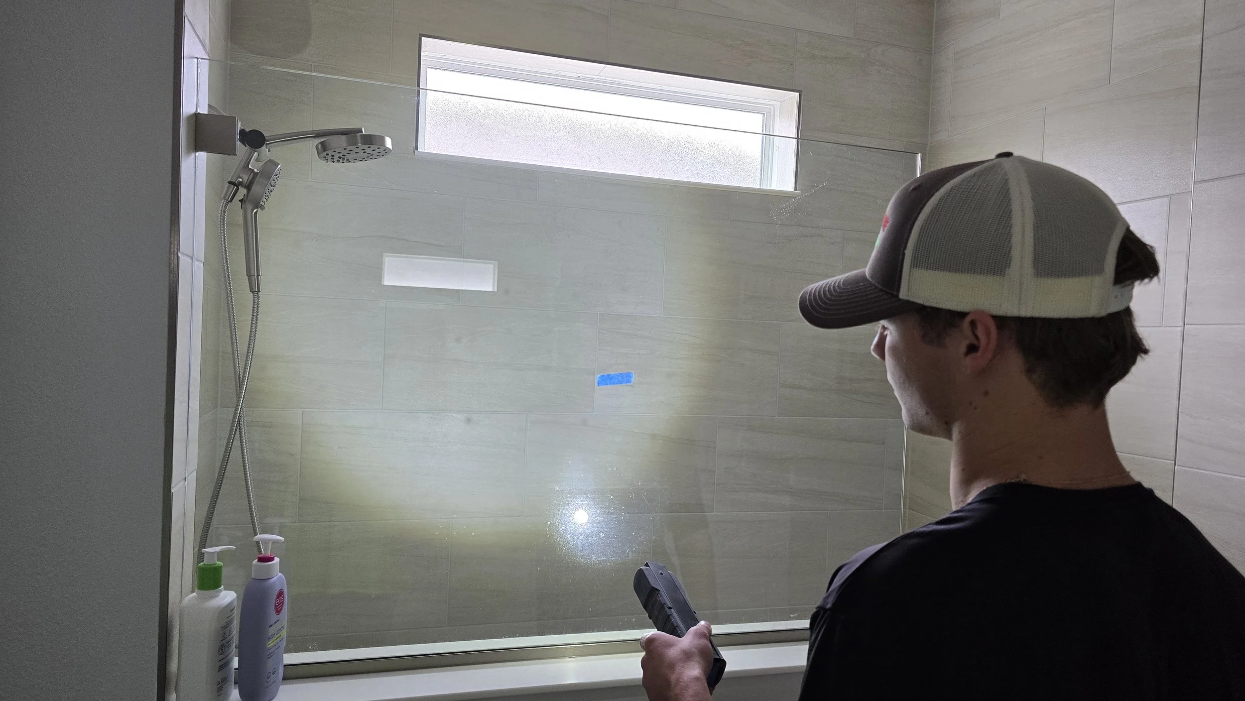 New construction shower enclosure glass scratch repair at Bella Lago Parrish — Glass Restoration Inc. the glass restoration specialists for Manatee County D.R. Horton homes